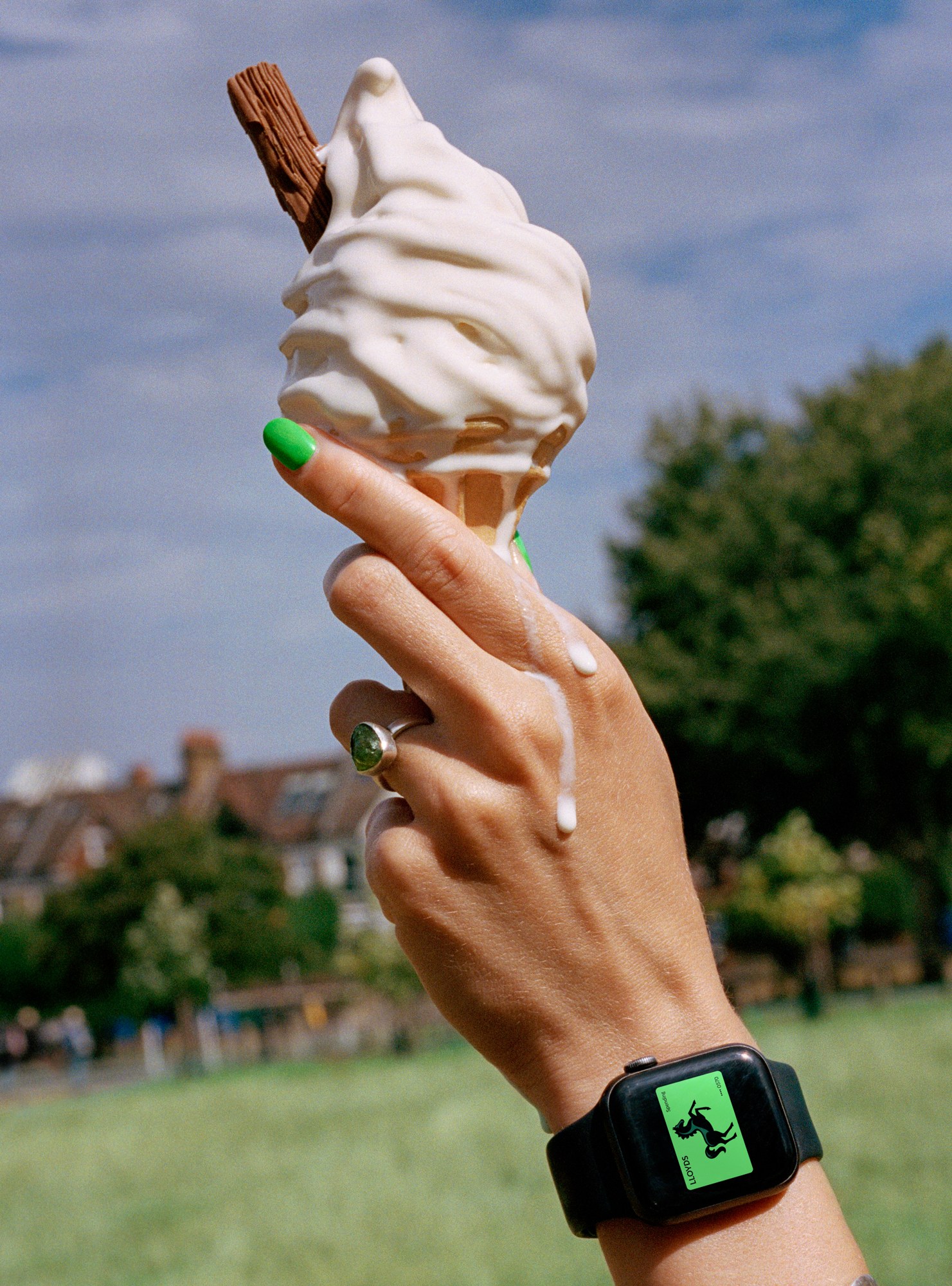 Lloyds horse logo on a smartwatch, 99 Flake in hand