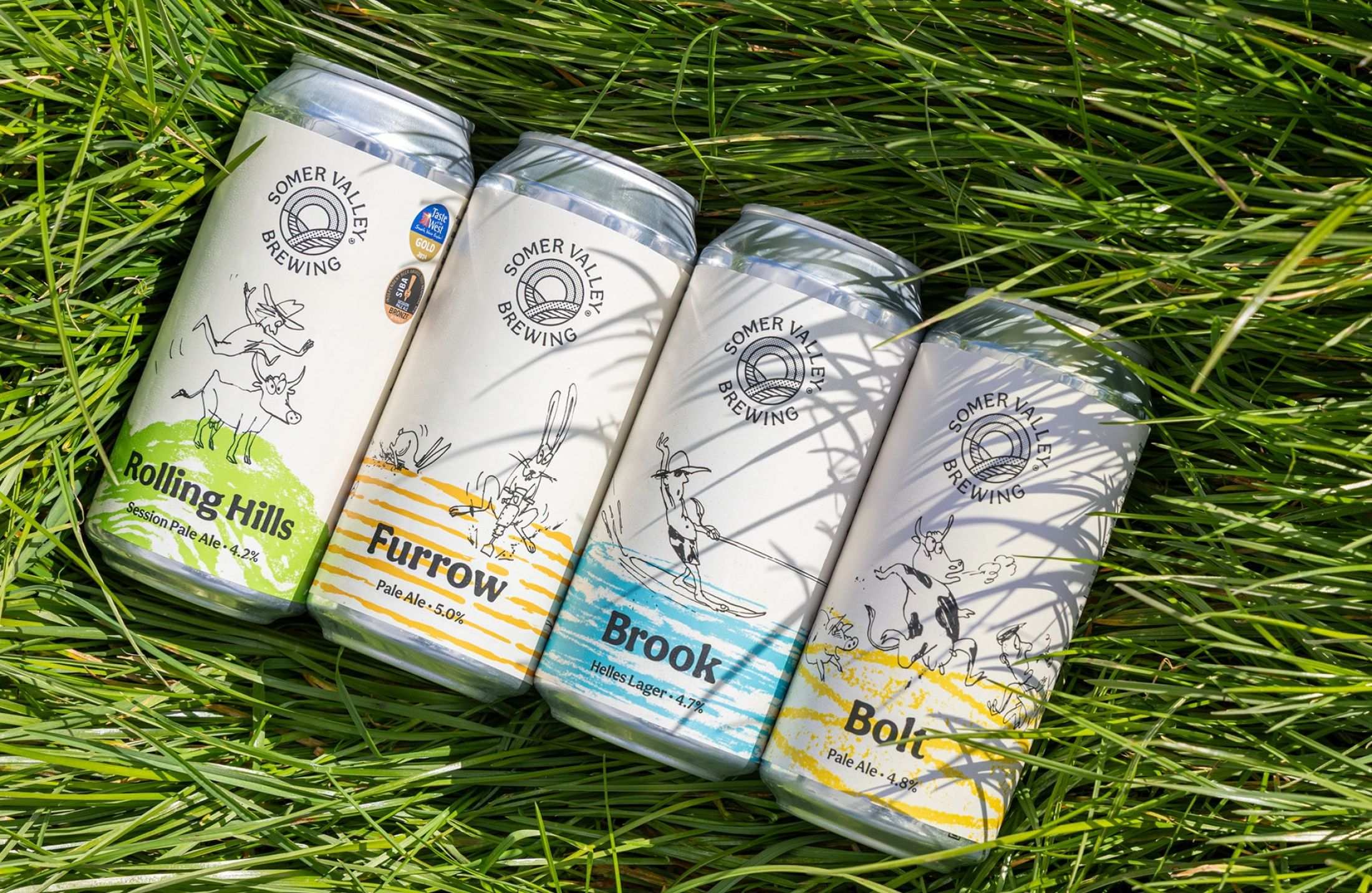 Rolling Hills, Furrow, Brook and Bolt cans in the grass