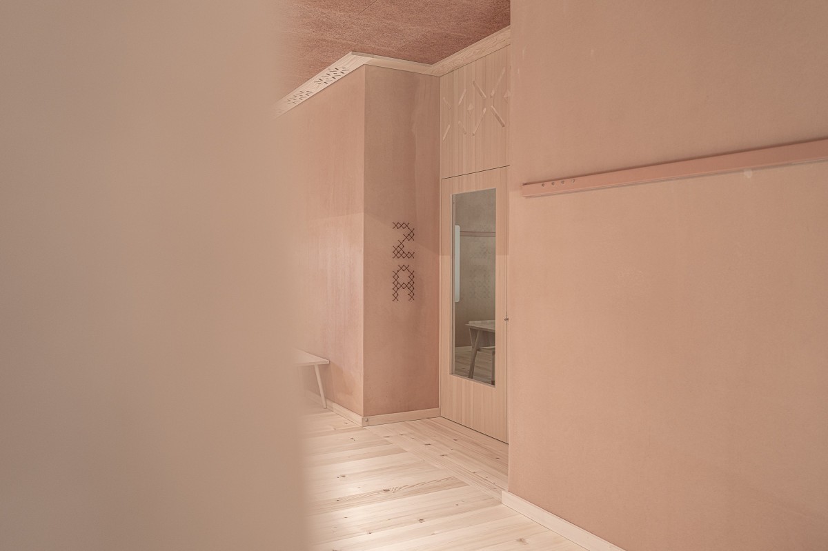 Upper gallery level of Education Center Kössen with copper wayfinding elements