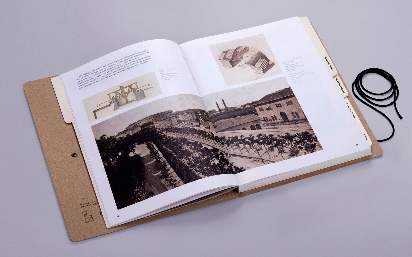 Open spread with period photographs and fortification construction drawings from the museum's archive.