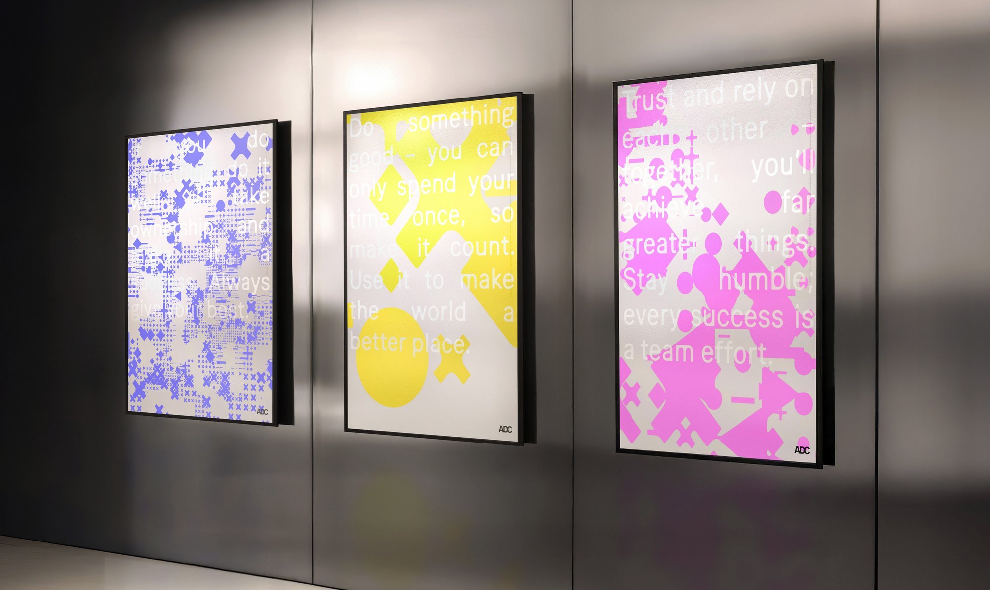 ADC identity posters installed on a gallery wall