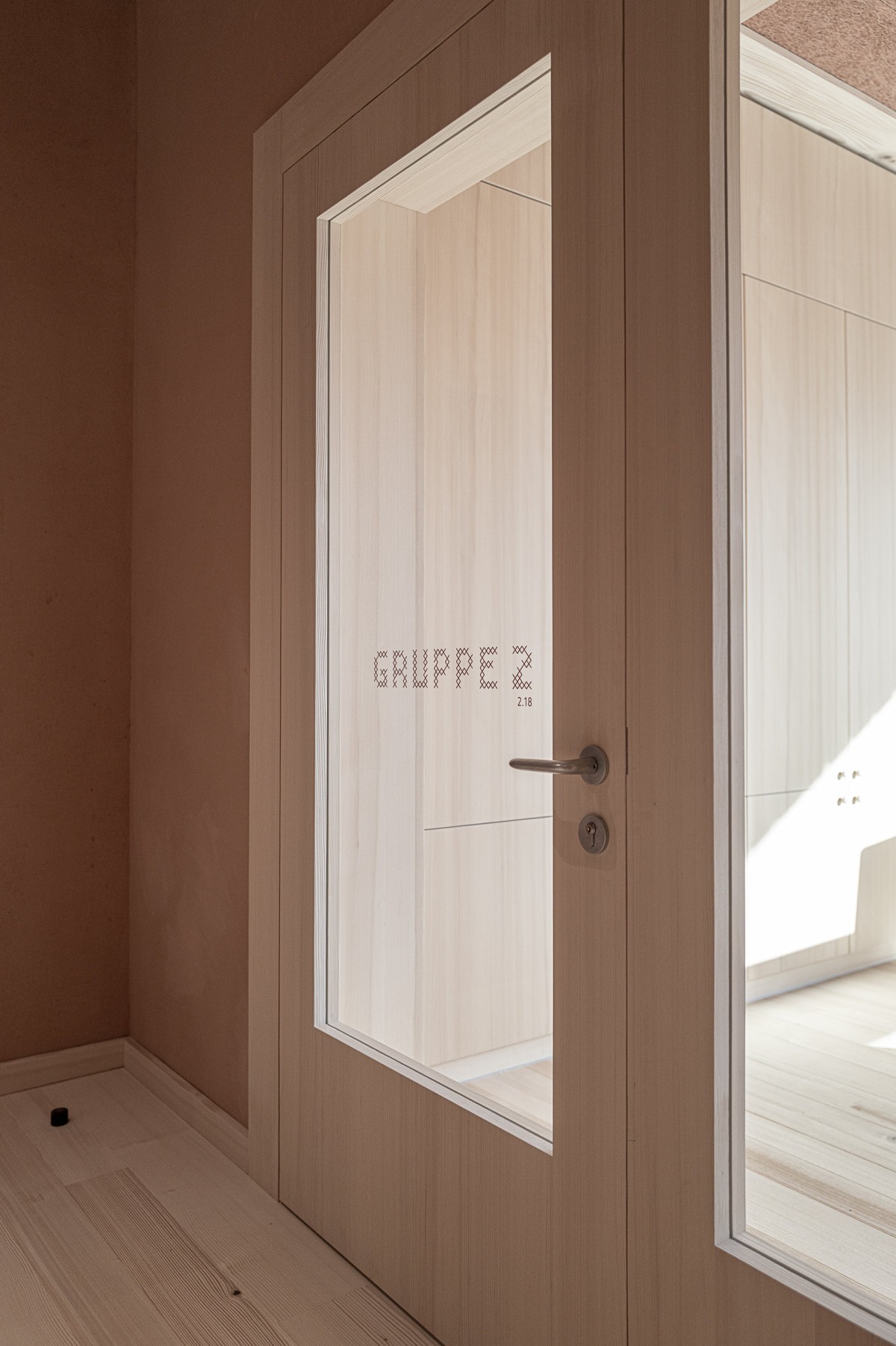Room sign GRUPPE 2 in stitched copper lettering at Education Center Kössen