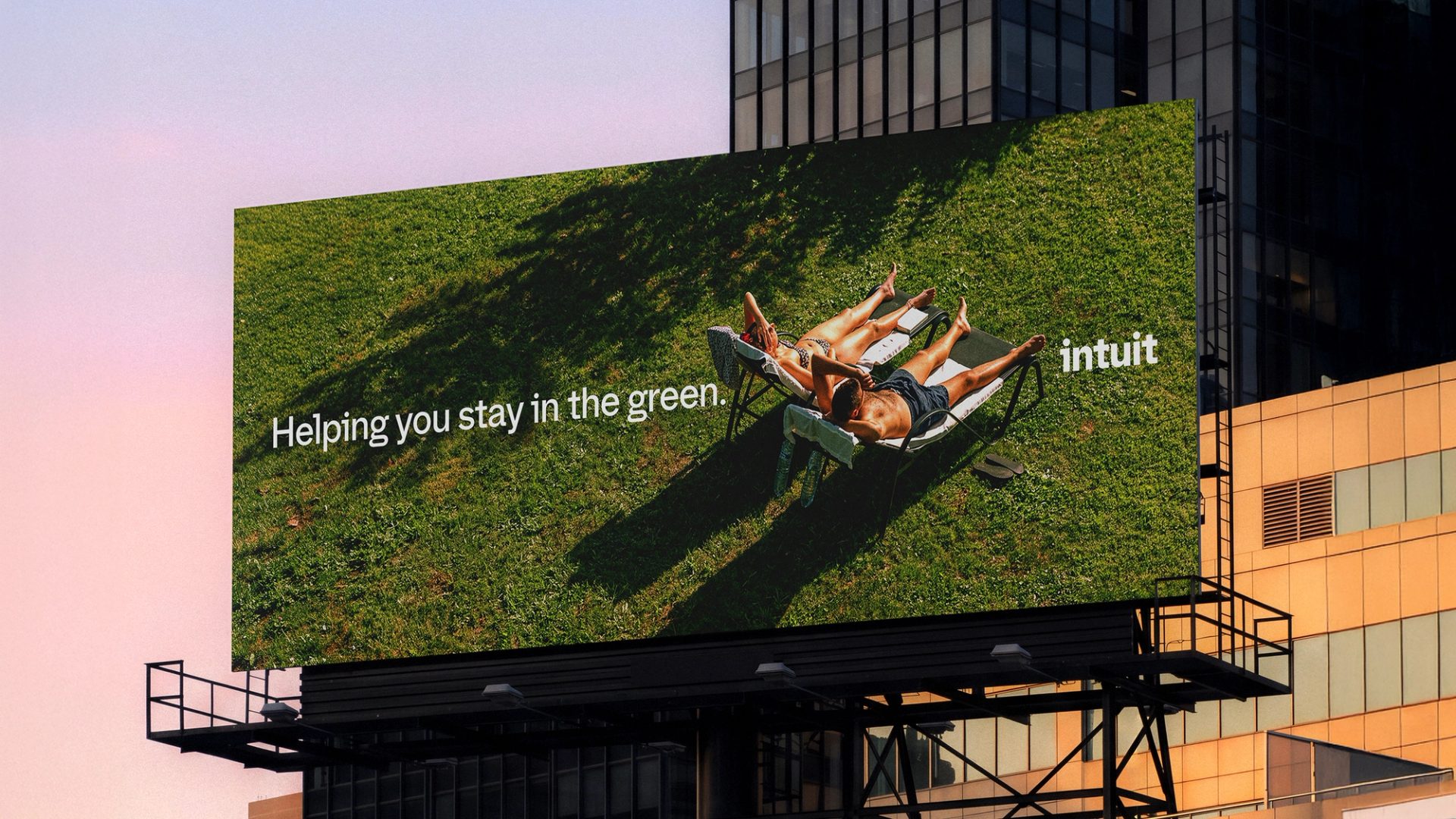 Billboard with the new lowercase Intuit wordmark and the headline Helping you stay in the green