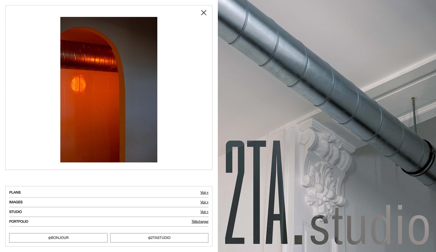 Clean typographic wall projection and editorial design layout for 2TA Studio