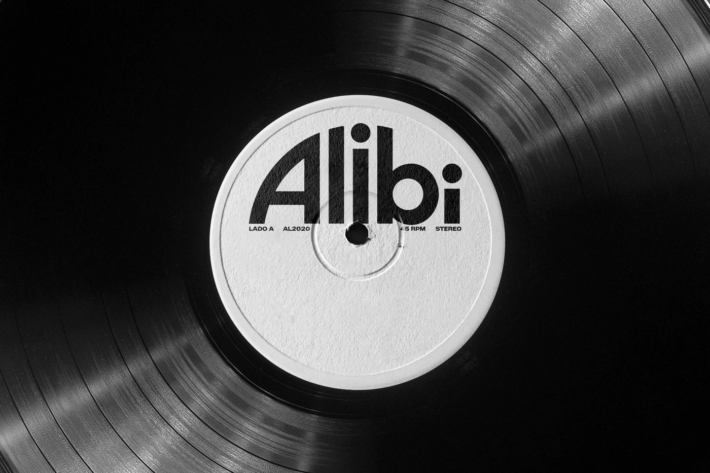 Macro vinyl record grooves with centered white Alibi Records label and spindle hole telemetry