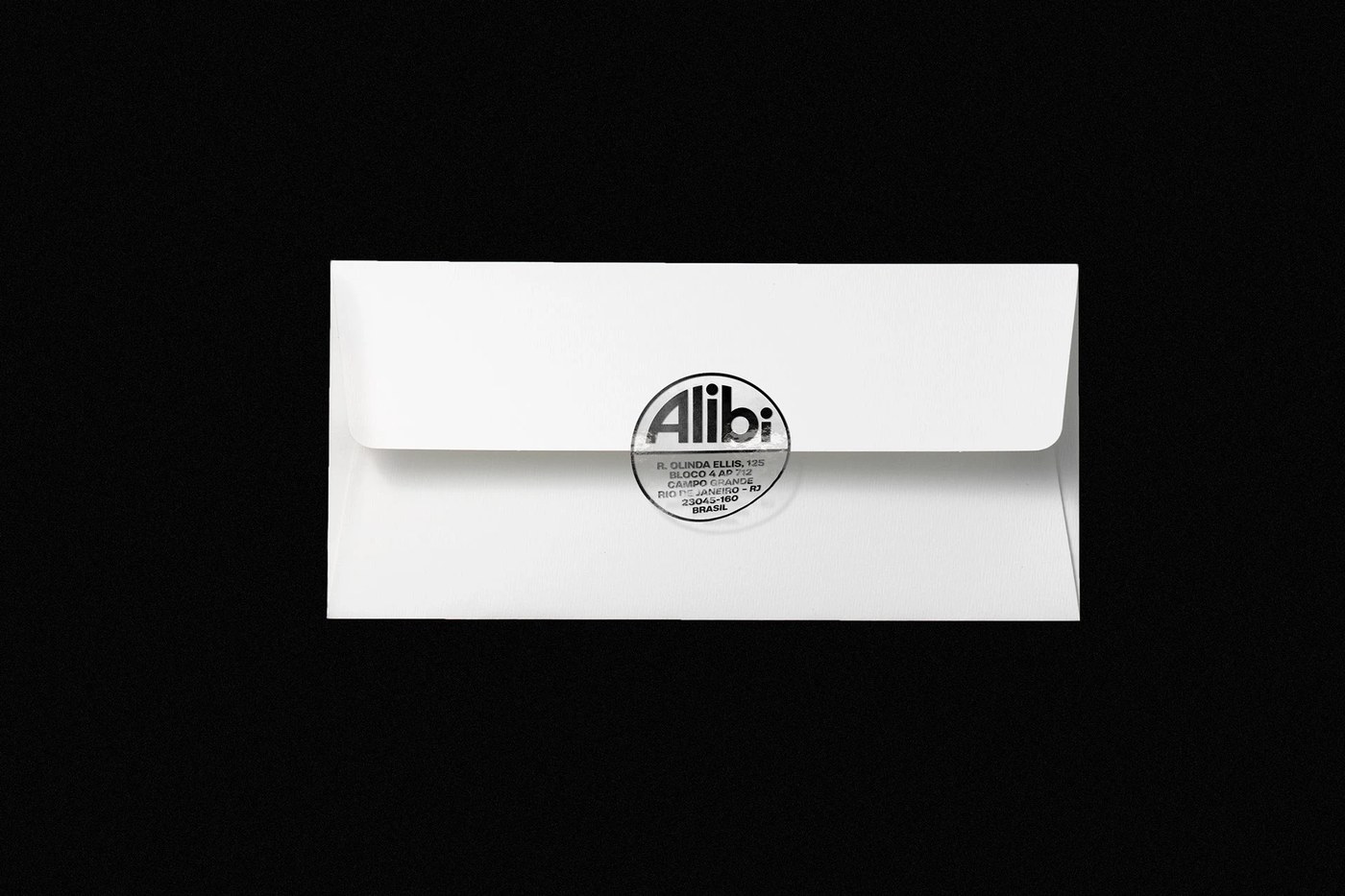 White correspondence envelope sealed with circular transparent gloss Alibi Records emblem sticker
