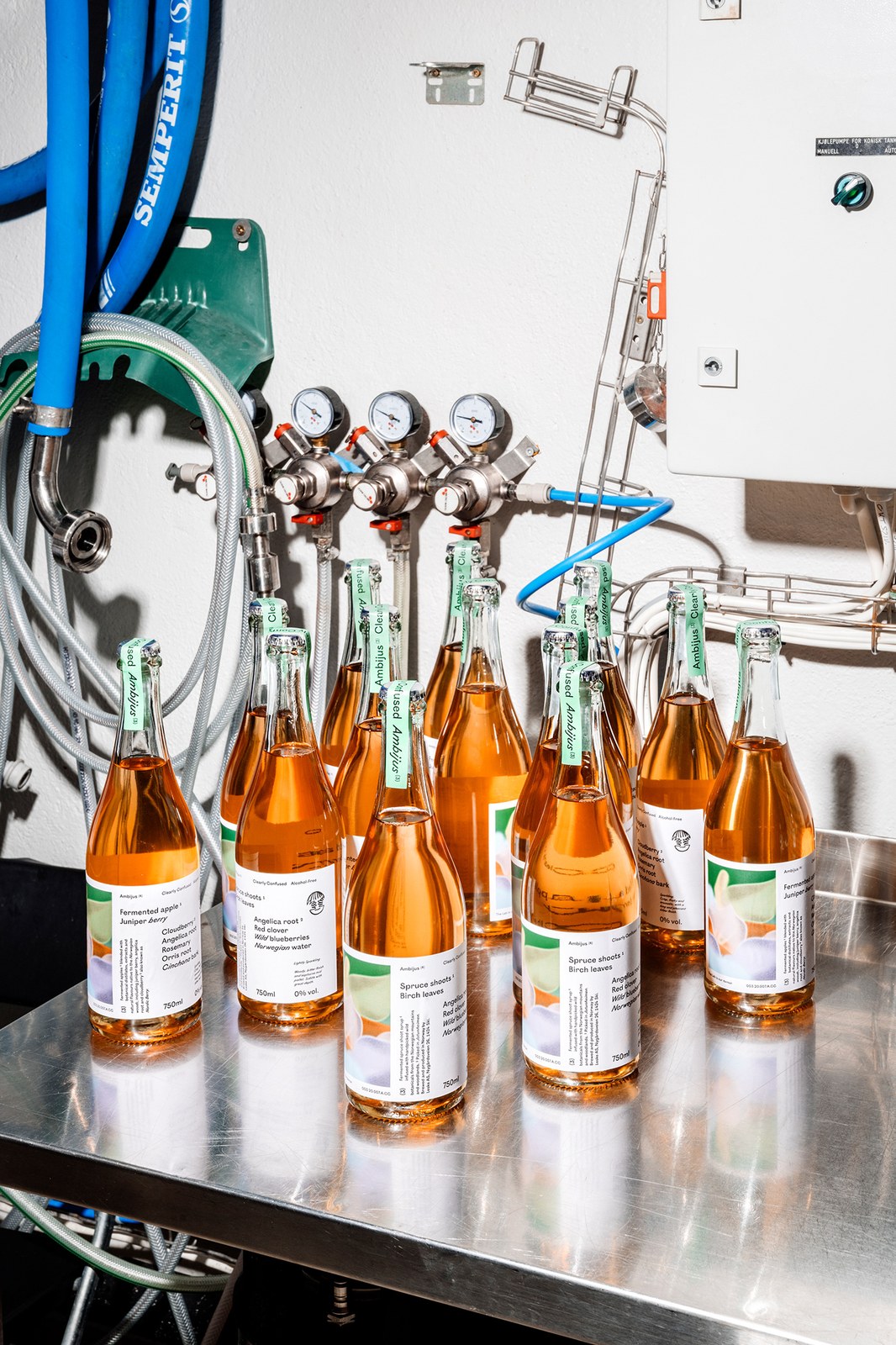 Amber Ambijus Clearly Confused bottles with mint-green neck seals beneath fermentation pressure gauges — packaging design by OlssønBarbieri