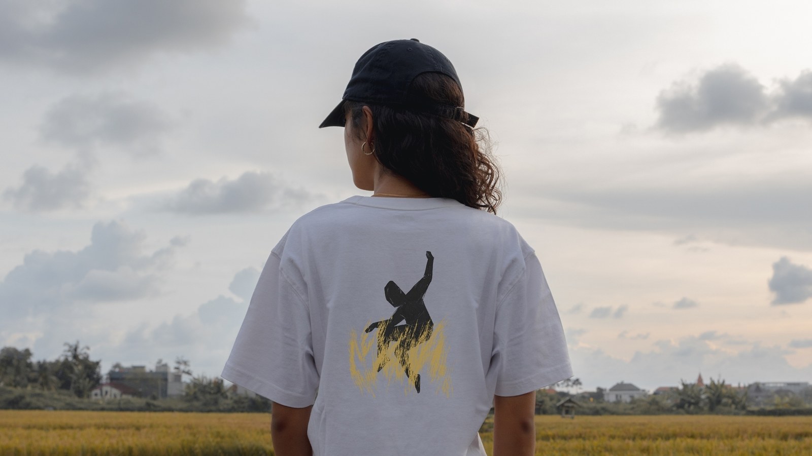Arado 2026 white t-shirt back print with dancer emblem — brand identity by Senhor Paulinho