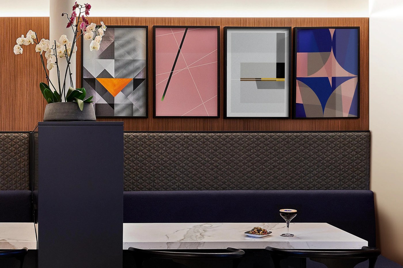 Framed geometric wall art piece installed above leather seating in Crowne Plaza Paris République lounge