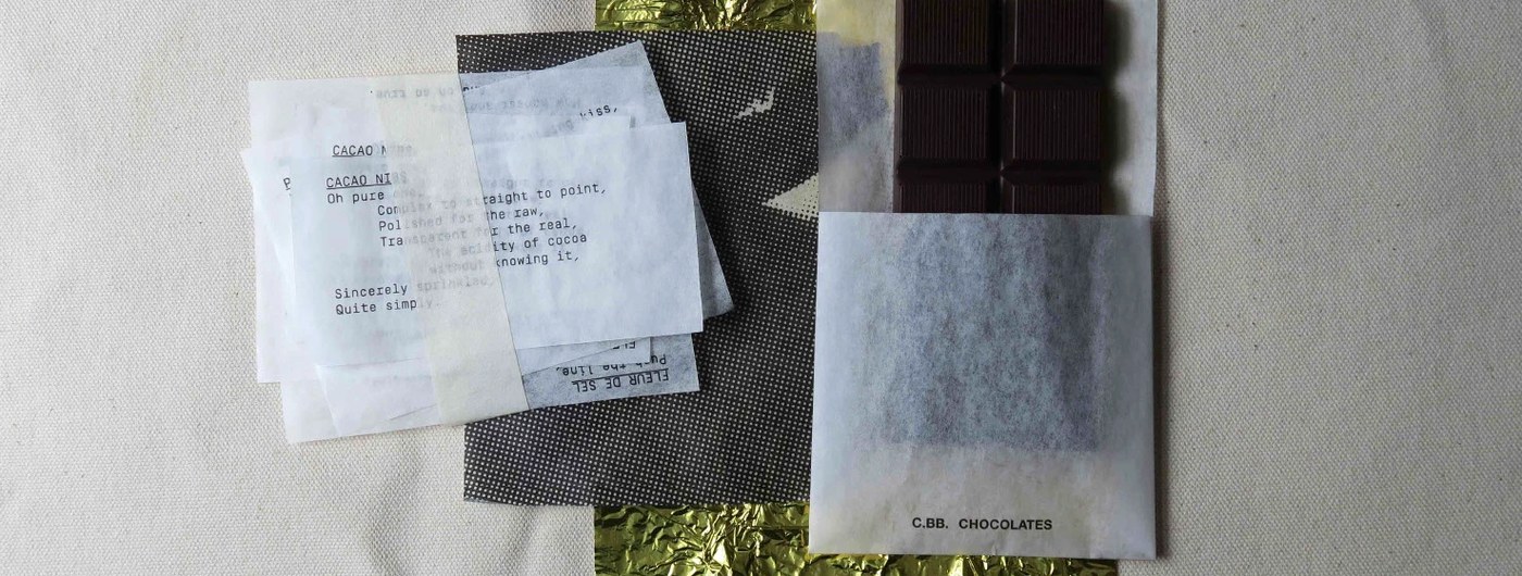 Casa Bosques chocolate packaging design showing poetry slips and chocolate bar in glassine sleeve by SAVVY STUDIO