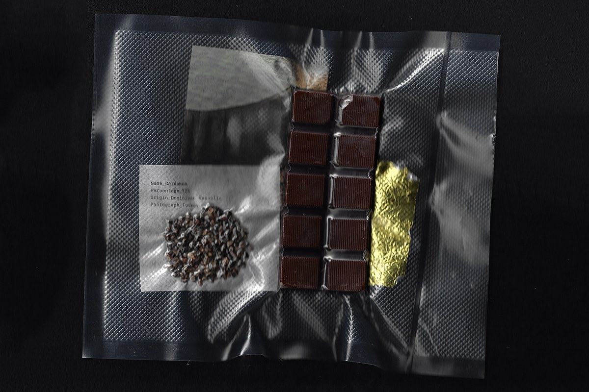Vacuum-sealed ingredient pouch displaying cardamom seeds and segmented chocolate packaging design by SAVVY STUDIO