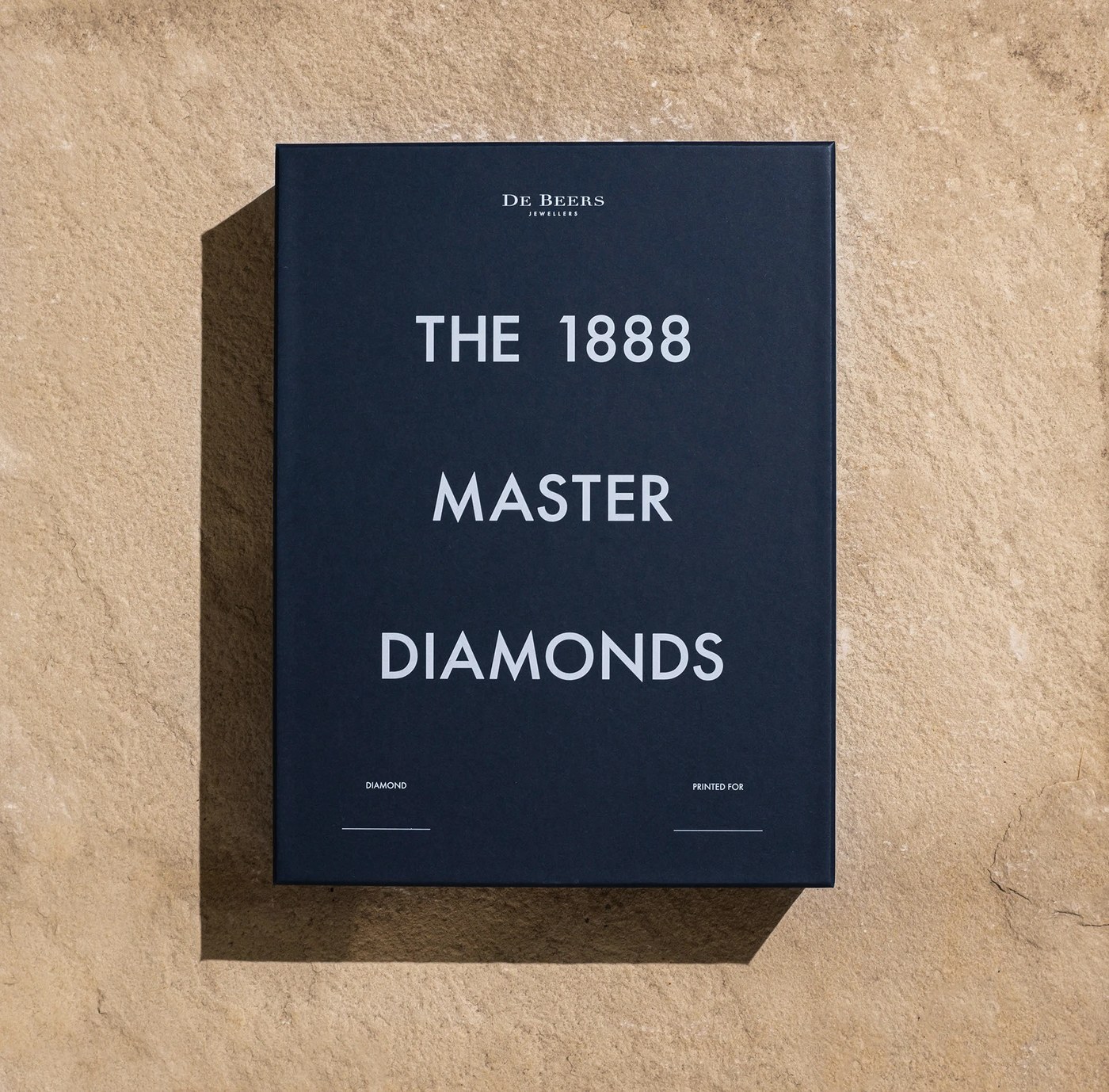 The 1888 Master Diamonds presentation box and monograph on sandstone slab — branding by Two Times Elliott
