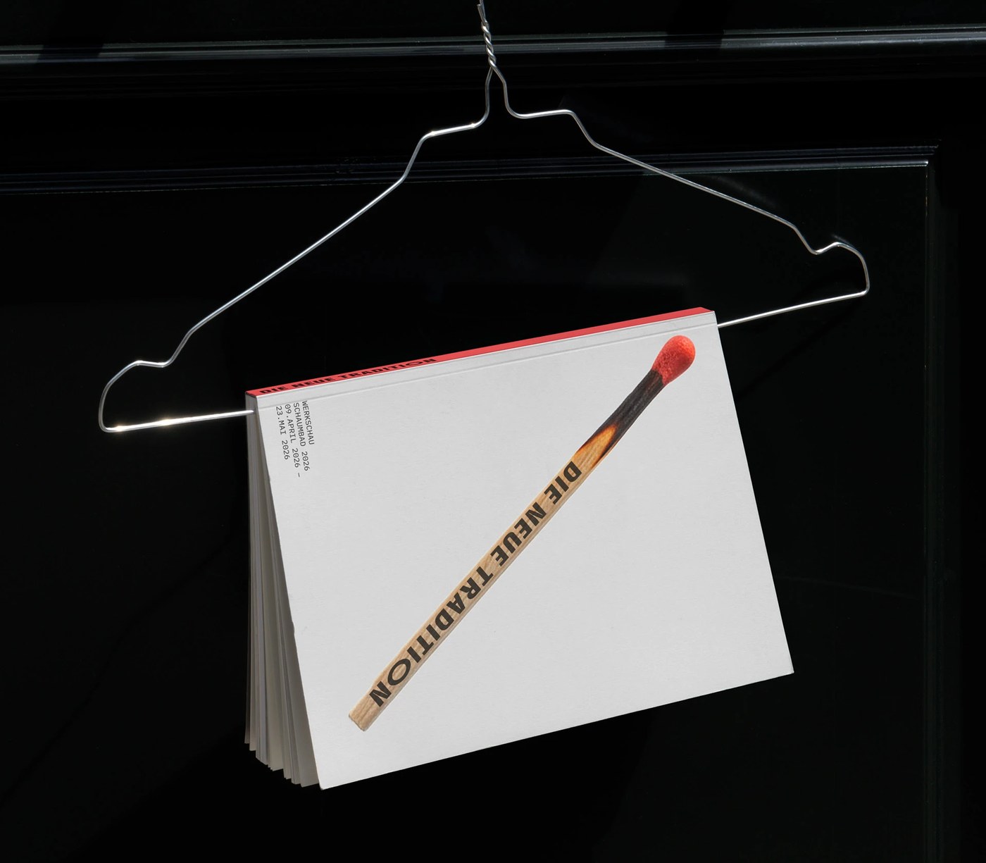 Printed catalog sheets hung on walls illustrating the exhibition editorial design