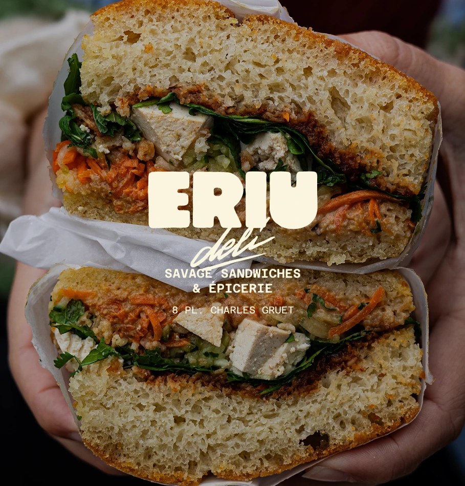 Eriu Deli storefront signage with hand-lettered logotype painted on glass in warm cream — handcrafted branding identity
