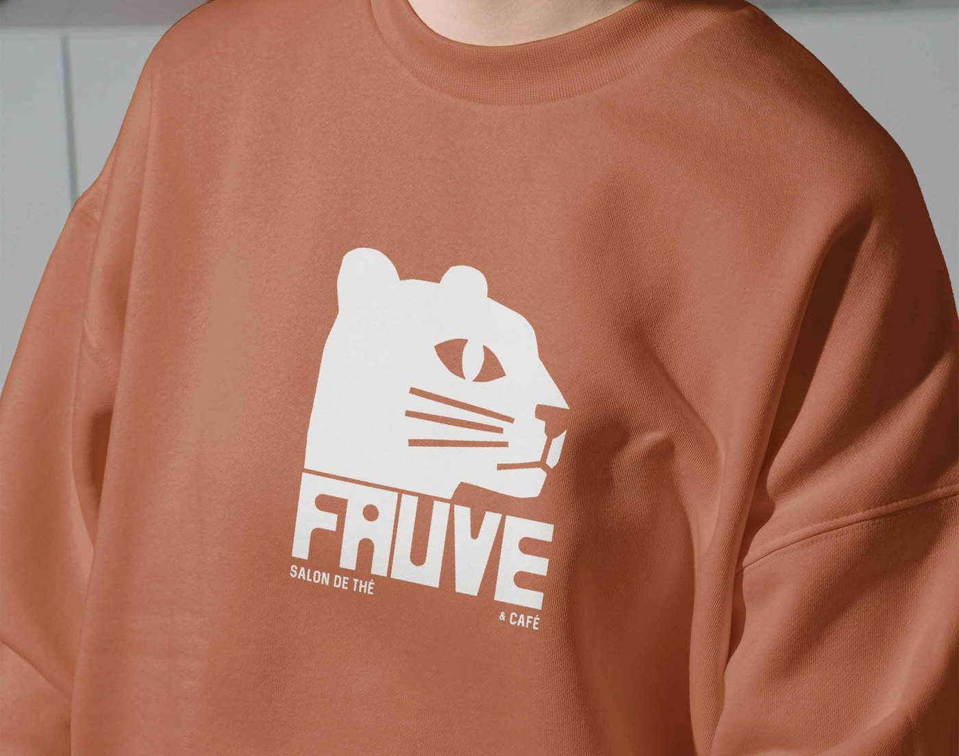 FAUVE brand identity terracotta staff sweatshirt with screen-printed white logo