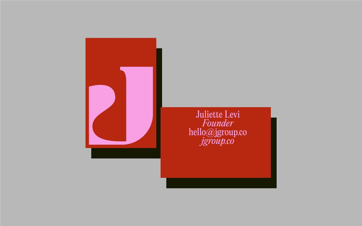 Stationery suite business cards with high-contrast typography on terracotta and pink stock