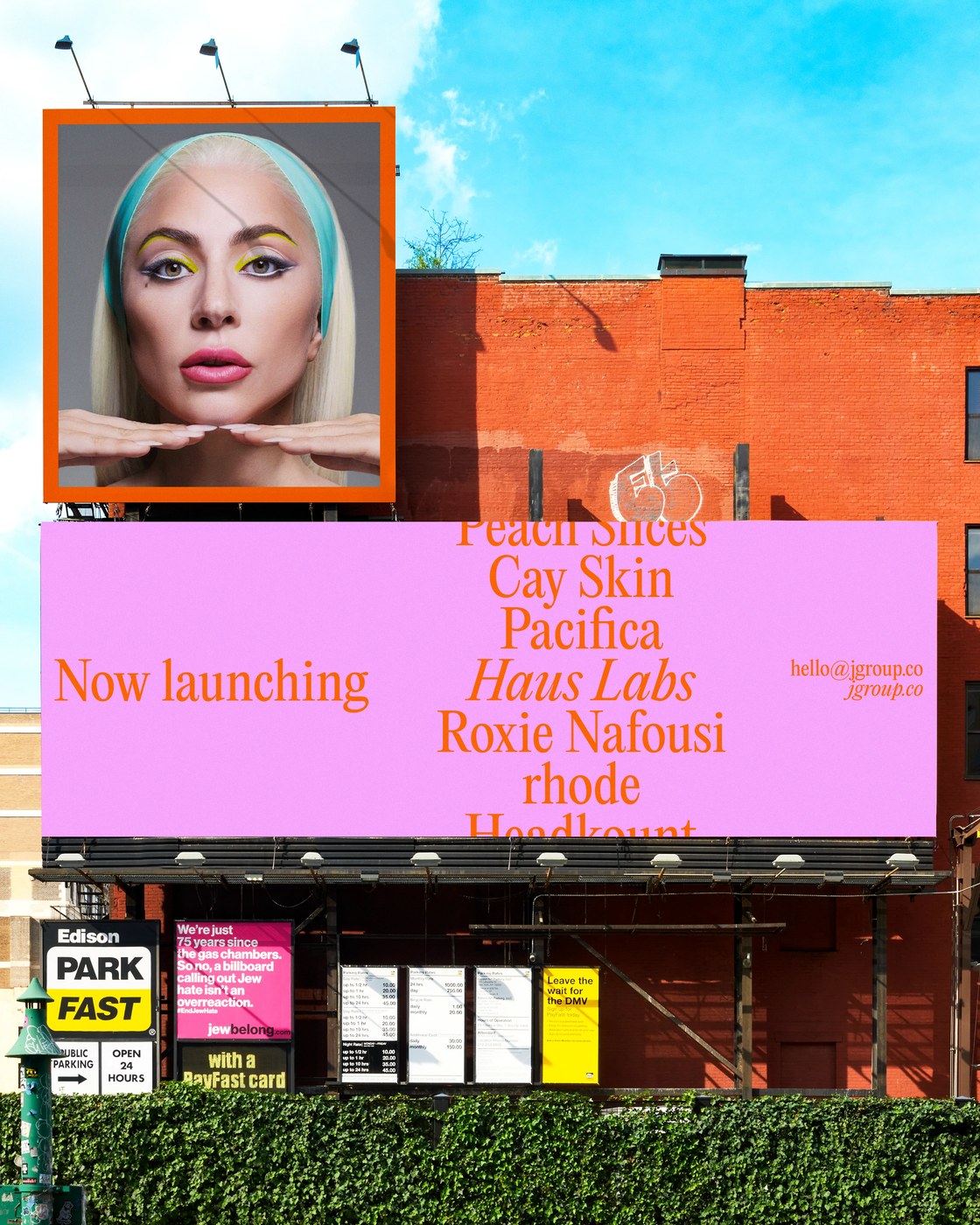 Large-scale urban billboard campaign displaying vibrant pink and orange typography