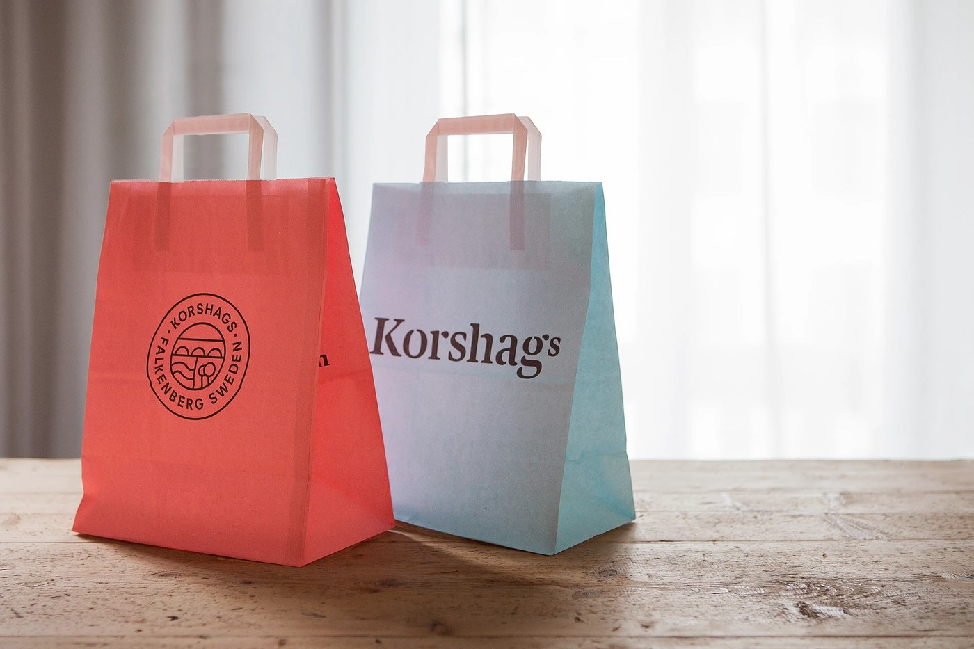 Paper carrier bags on wooden table in packaging design by Kurppa Hosk