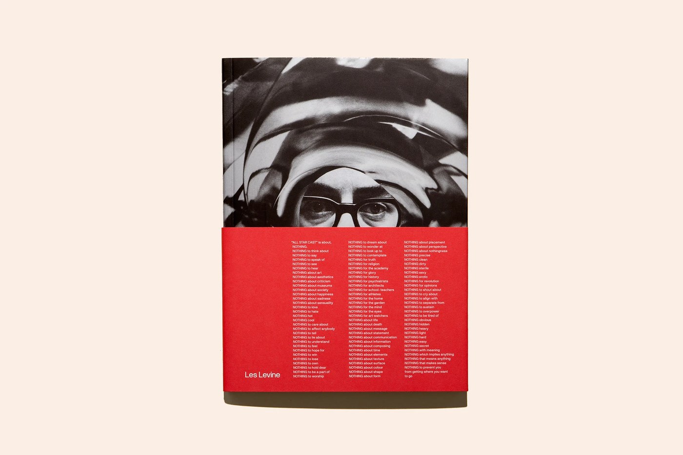 Catalogue cover showing distorted portrait of Les Levine and red bellyband in editorial design by Underline Studio
