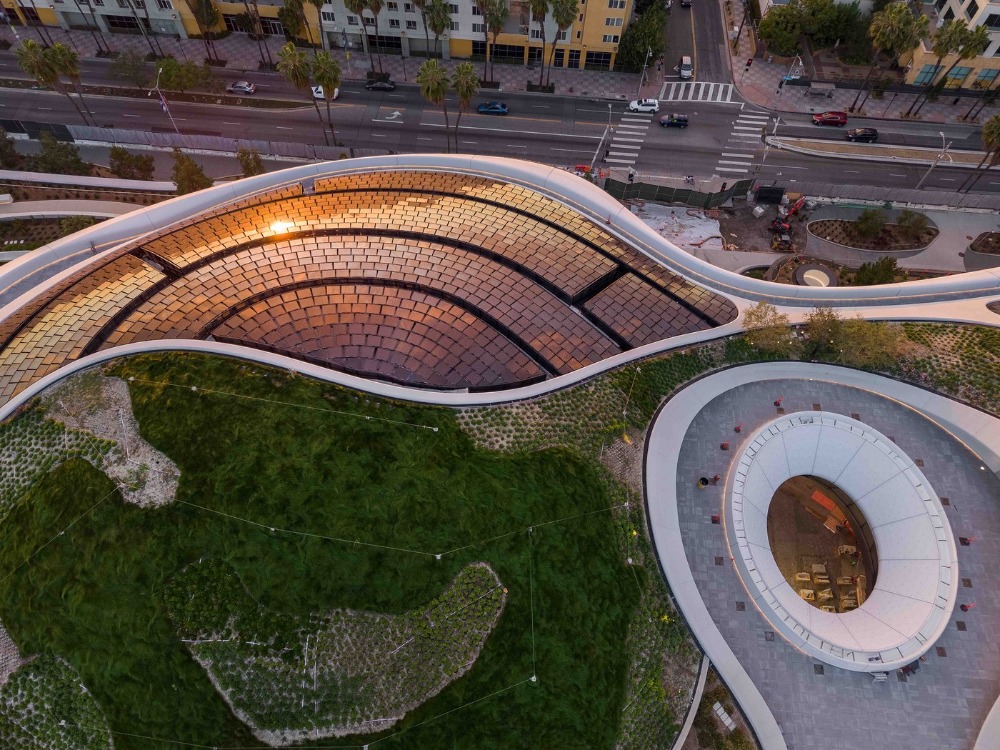 Cantilevered bridge canopy and shaded public pedestrian underpass at the Lucas Museum