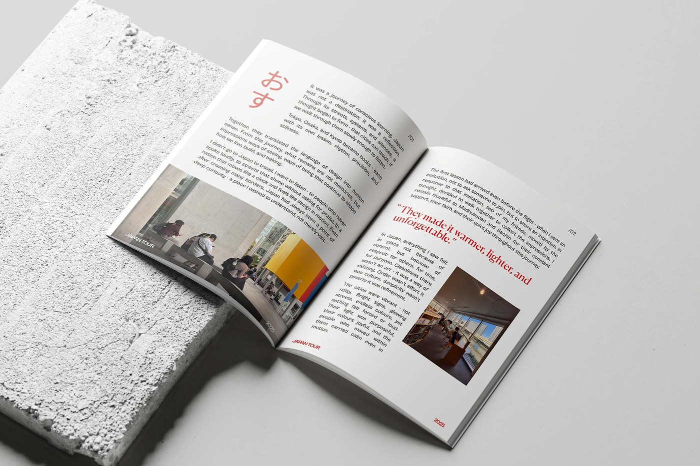 Angled physical mockup of open publication resting on porous stone in editorial design