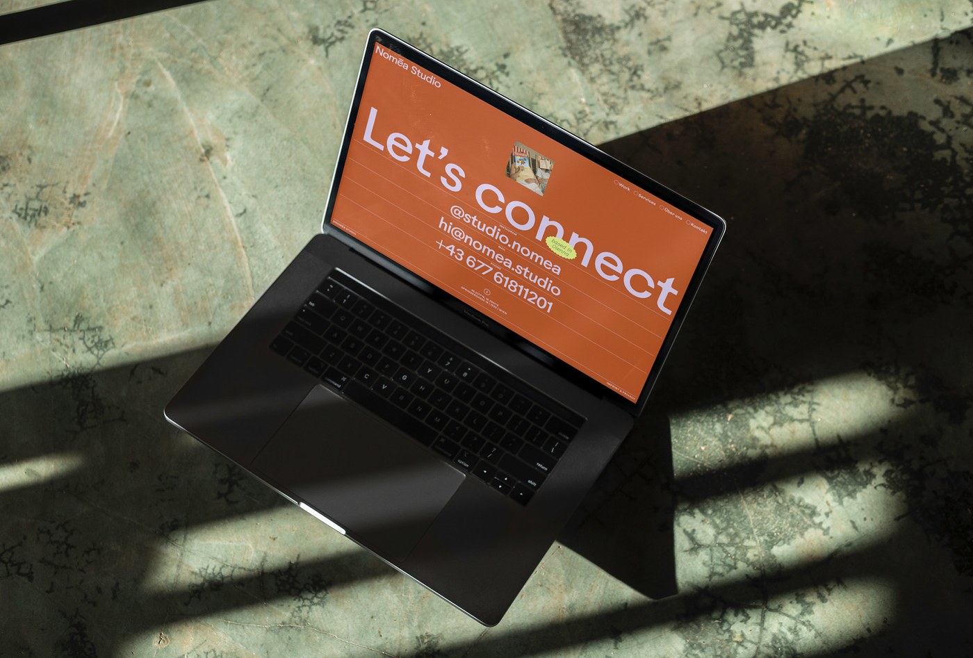 Nomēa Studio desktop website layout on laptop branding