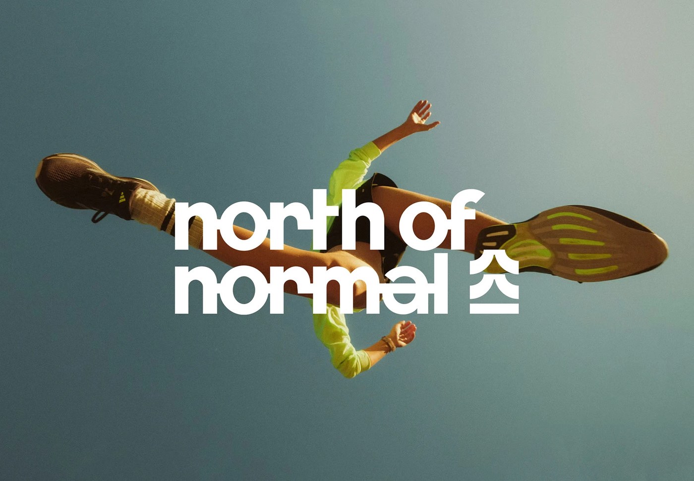 Overhead athletic runner jumping in sunlight with North of Normal branding design by Molnár Péter