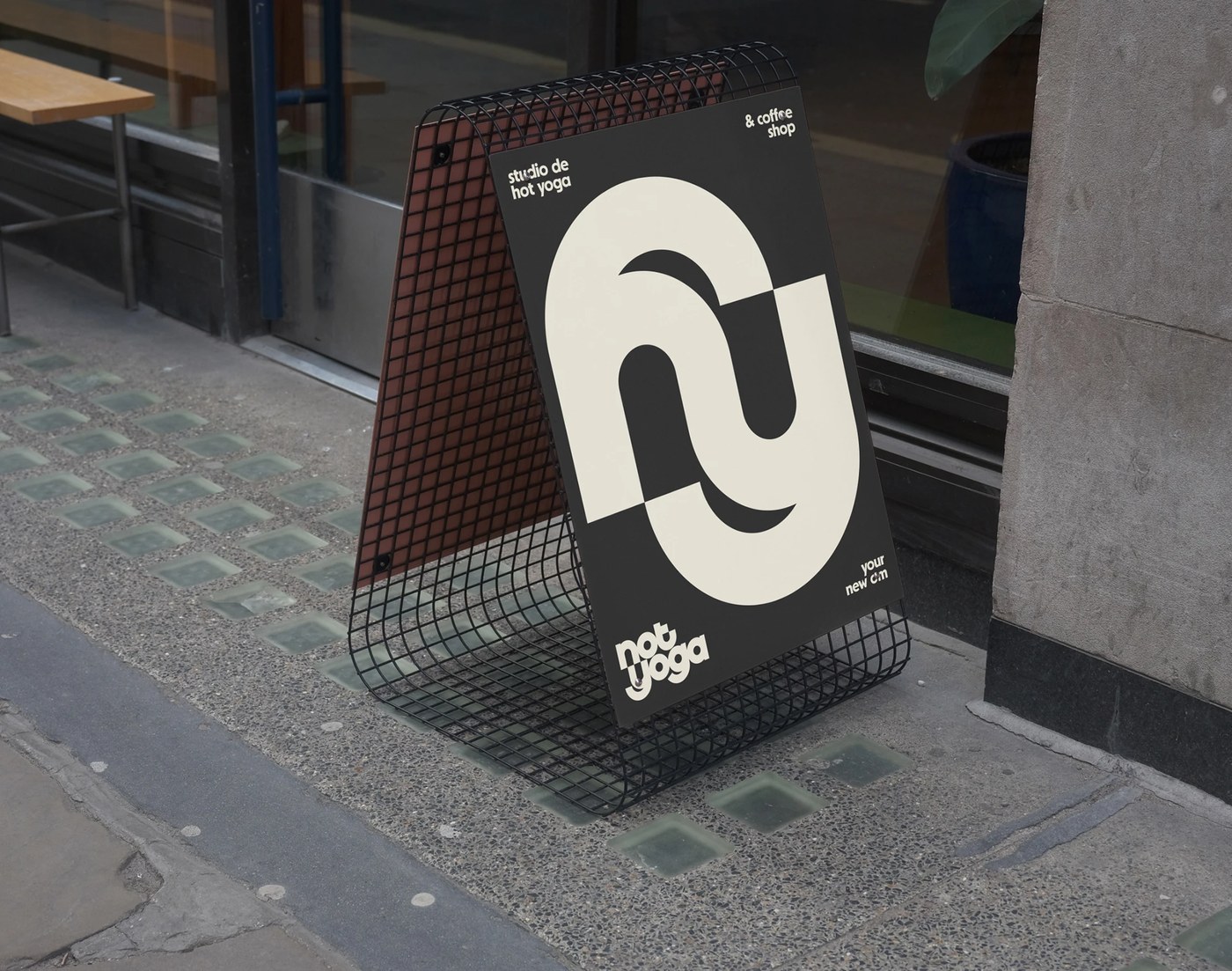 sidewalk A-frame signage featuring the monogram and coffee shop branding