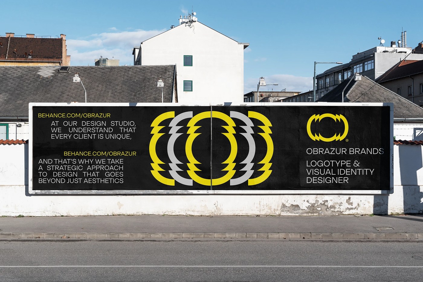 Large-scale horizontal street billboard featuring acid yellow kinetic typography