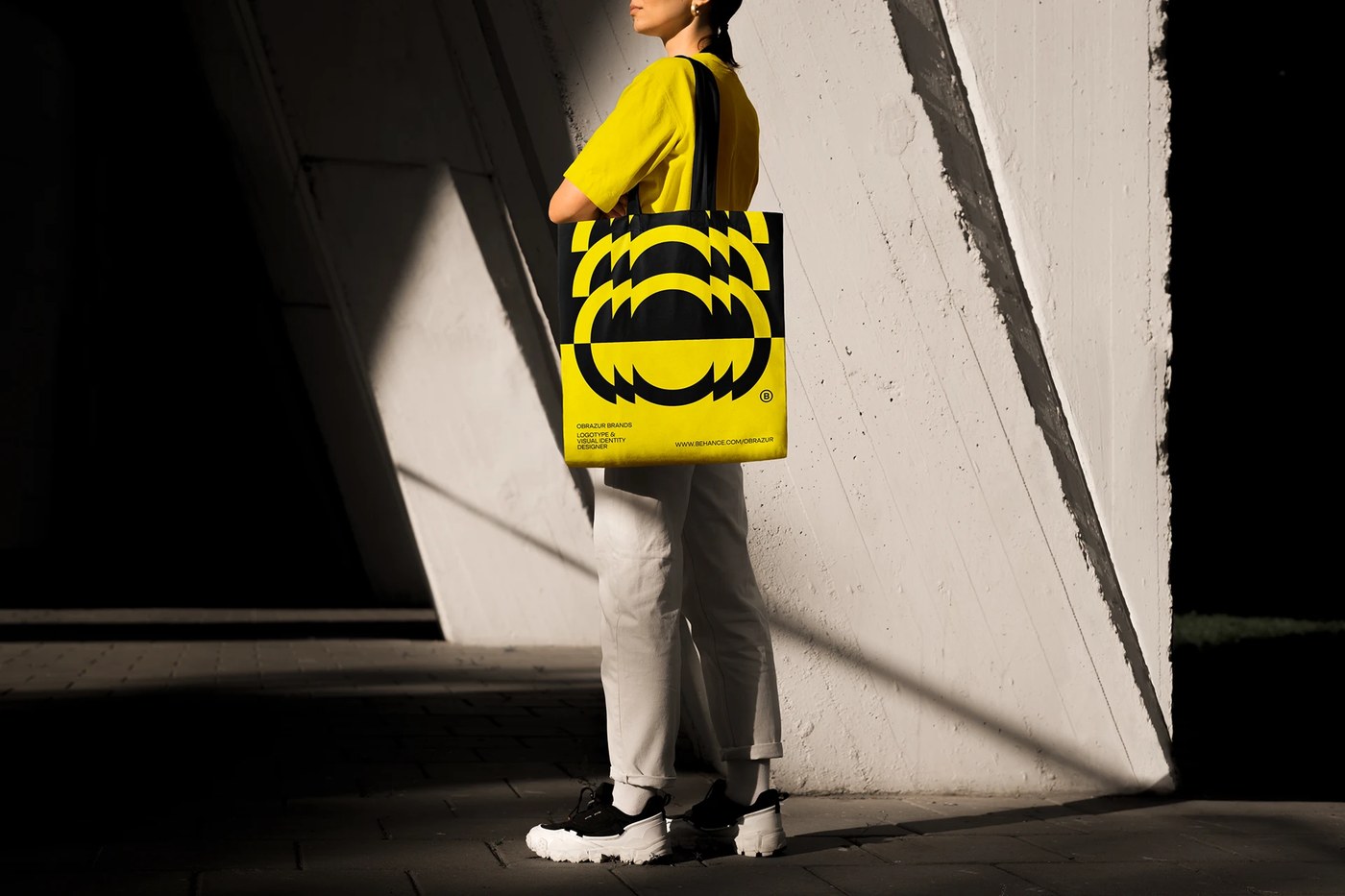 Screenprinted canvas tote bag with bold black and yellow geometric pattern