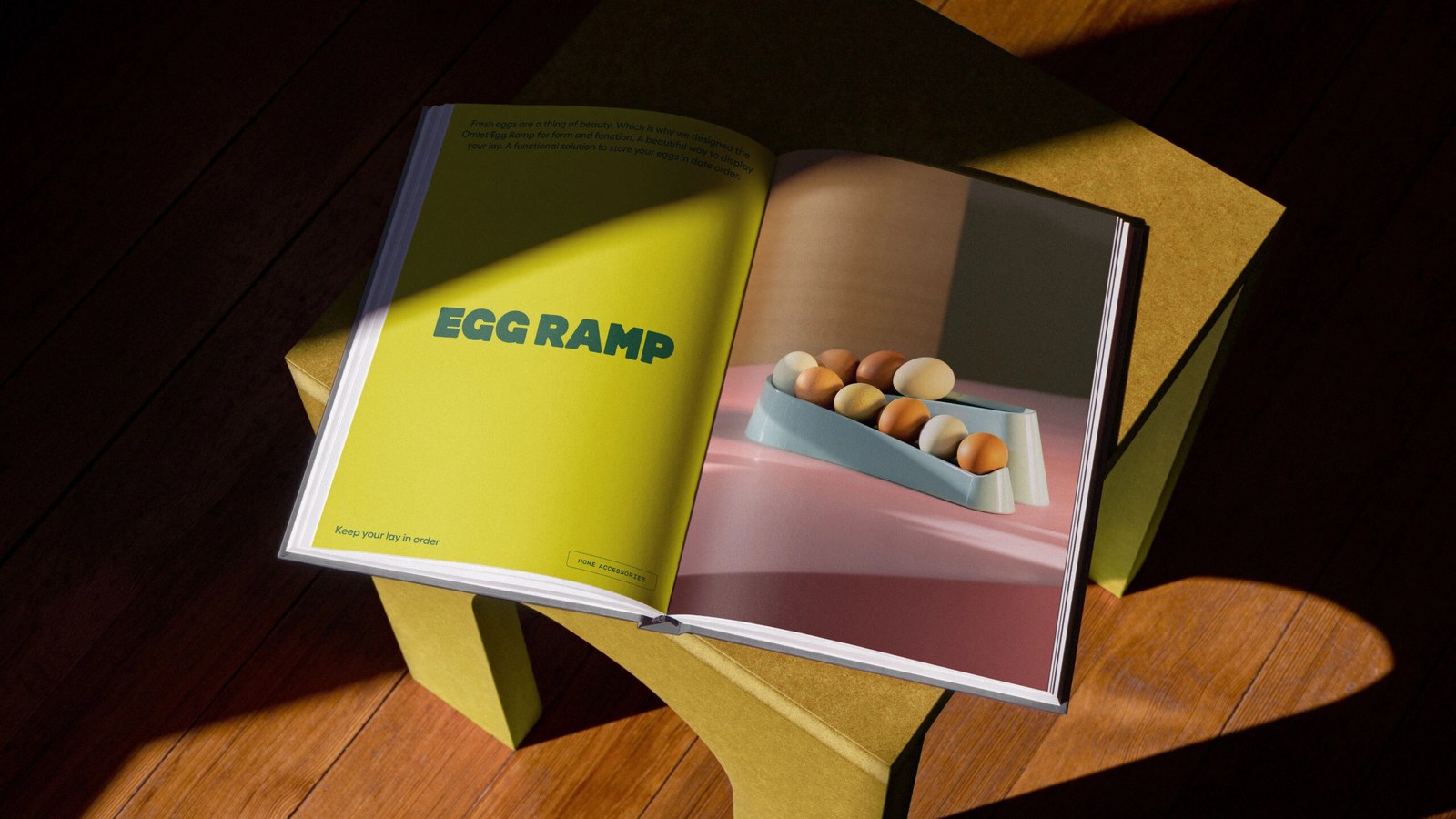Open hardcover product manual spread pairing chartreuse typography with studio photography of Omlet’s Egg Ramp in brand identity system
