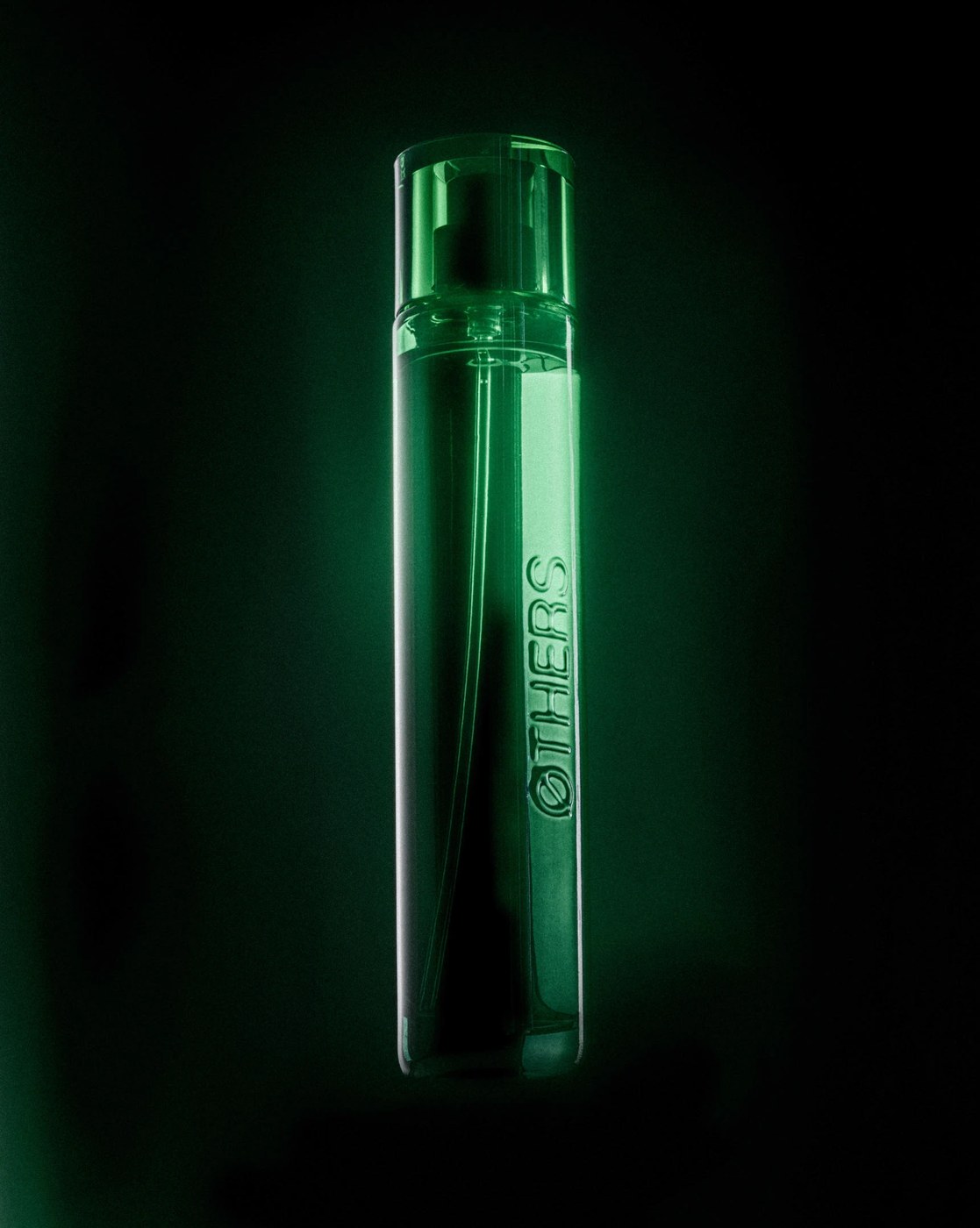 Cylindrical Mystic Zingaro glass vessel with embossed logotype in editorial design by Two Times Elliott