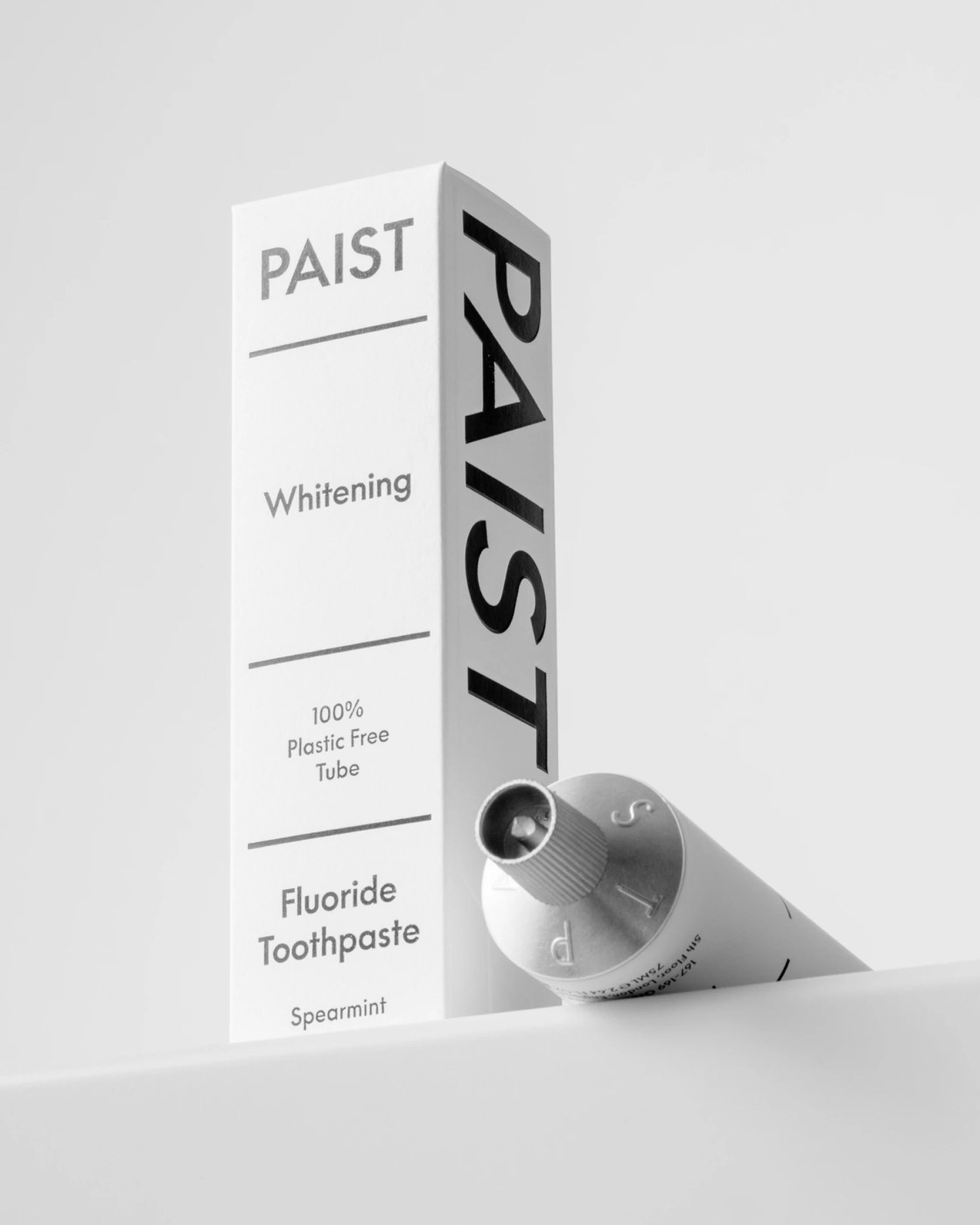 Paist structural paperboard retail carton with vertical typography alongside aluminum tube