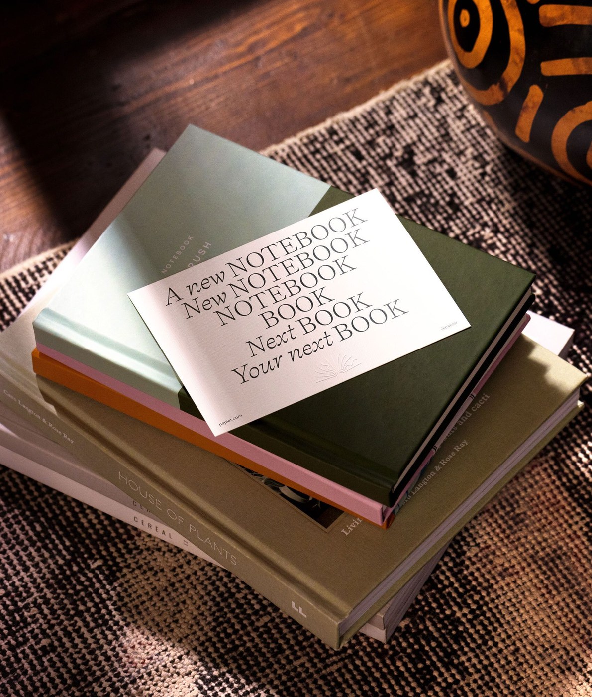 Printed stationery card and hardcover notebooks in Papier brand identity