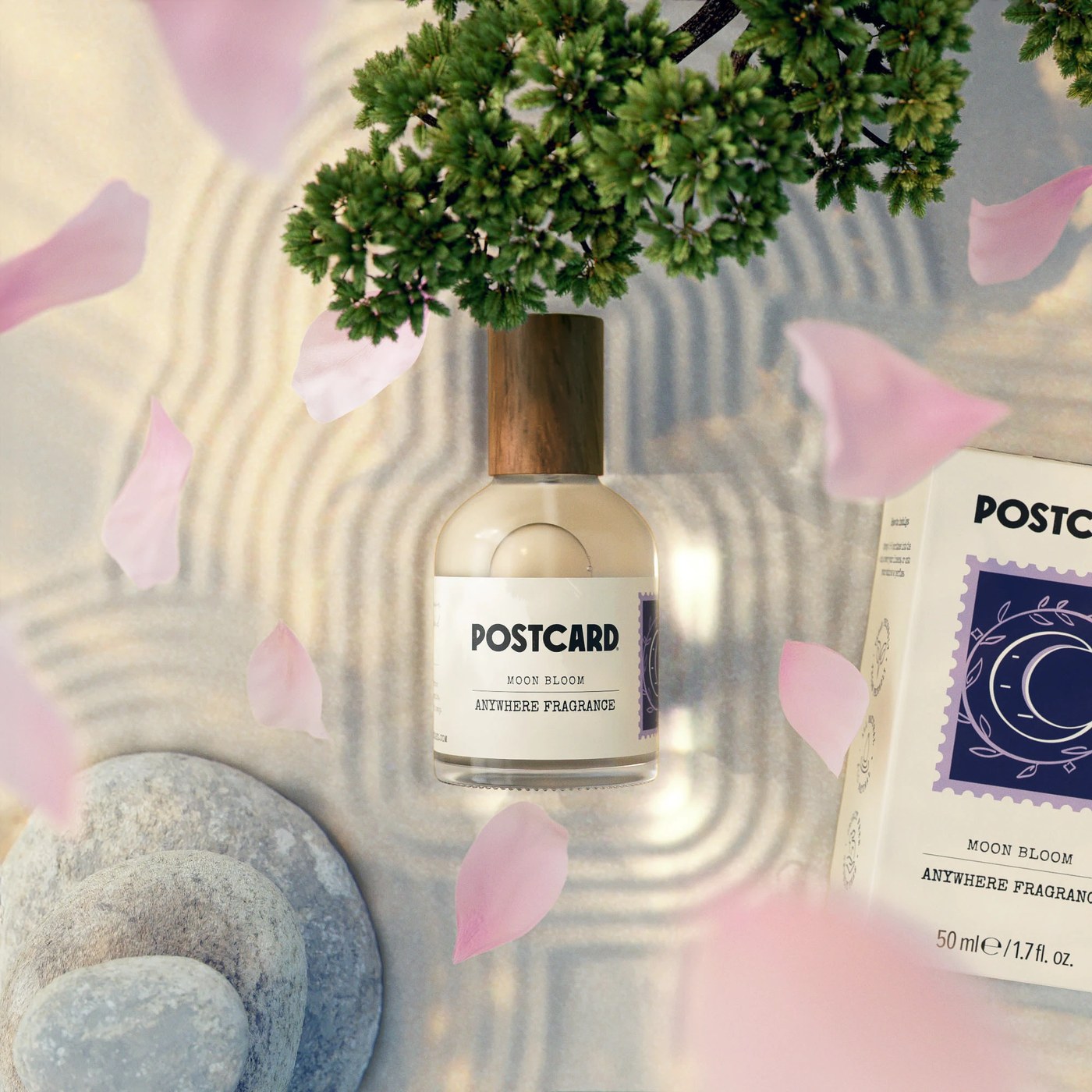 Postcard Moon Bloom Anywhere Fragrance bottle and crescent moon stamp carton on zen sand — packaging design by Robot Food