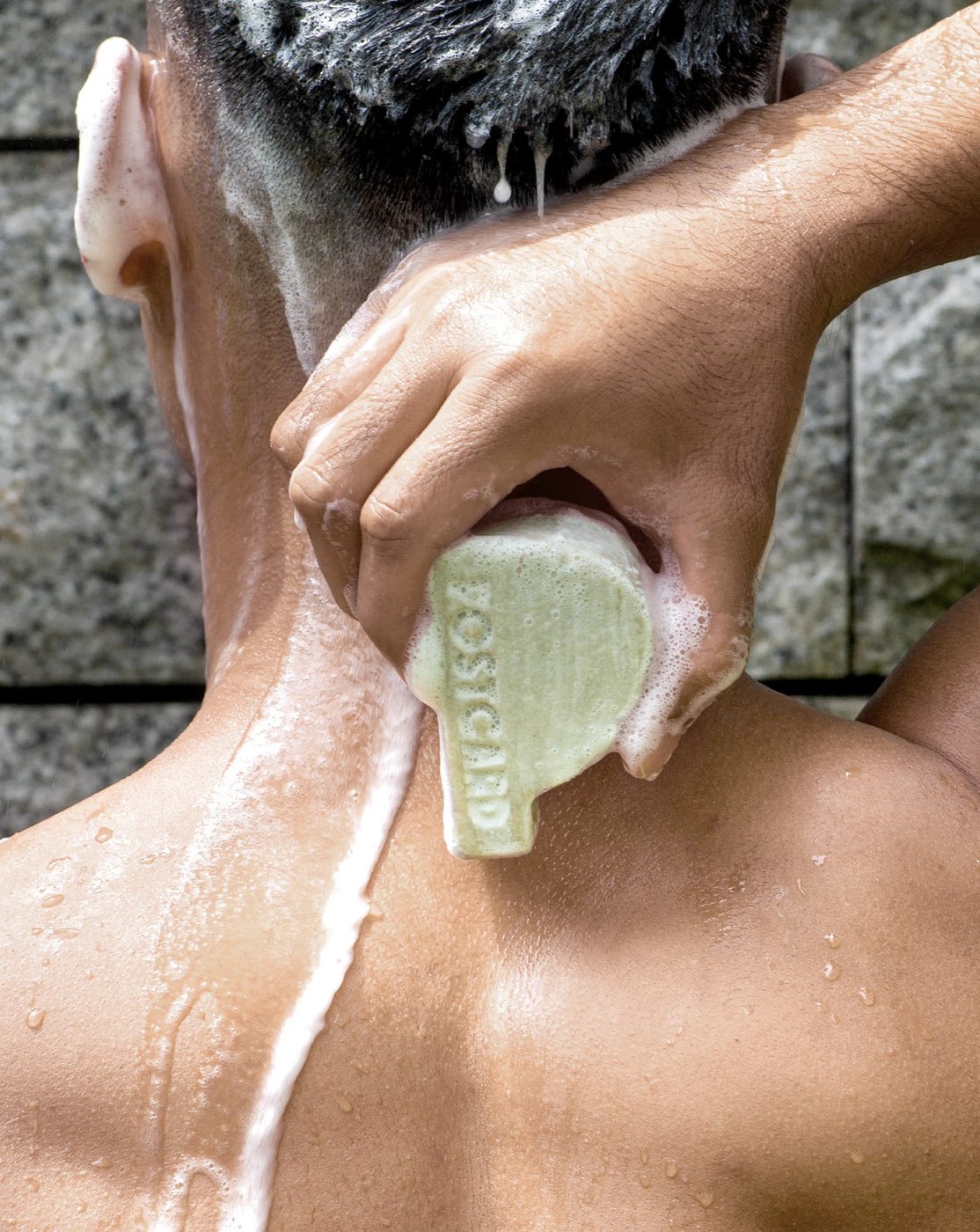 Postcard sage-green molded cleansing bar in shower use — packaging design by Robot Food