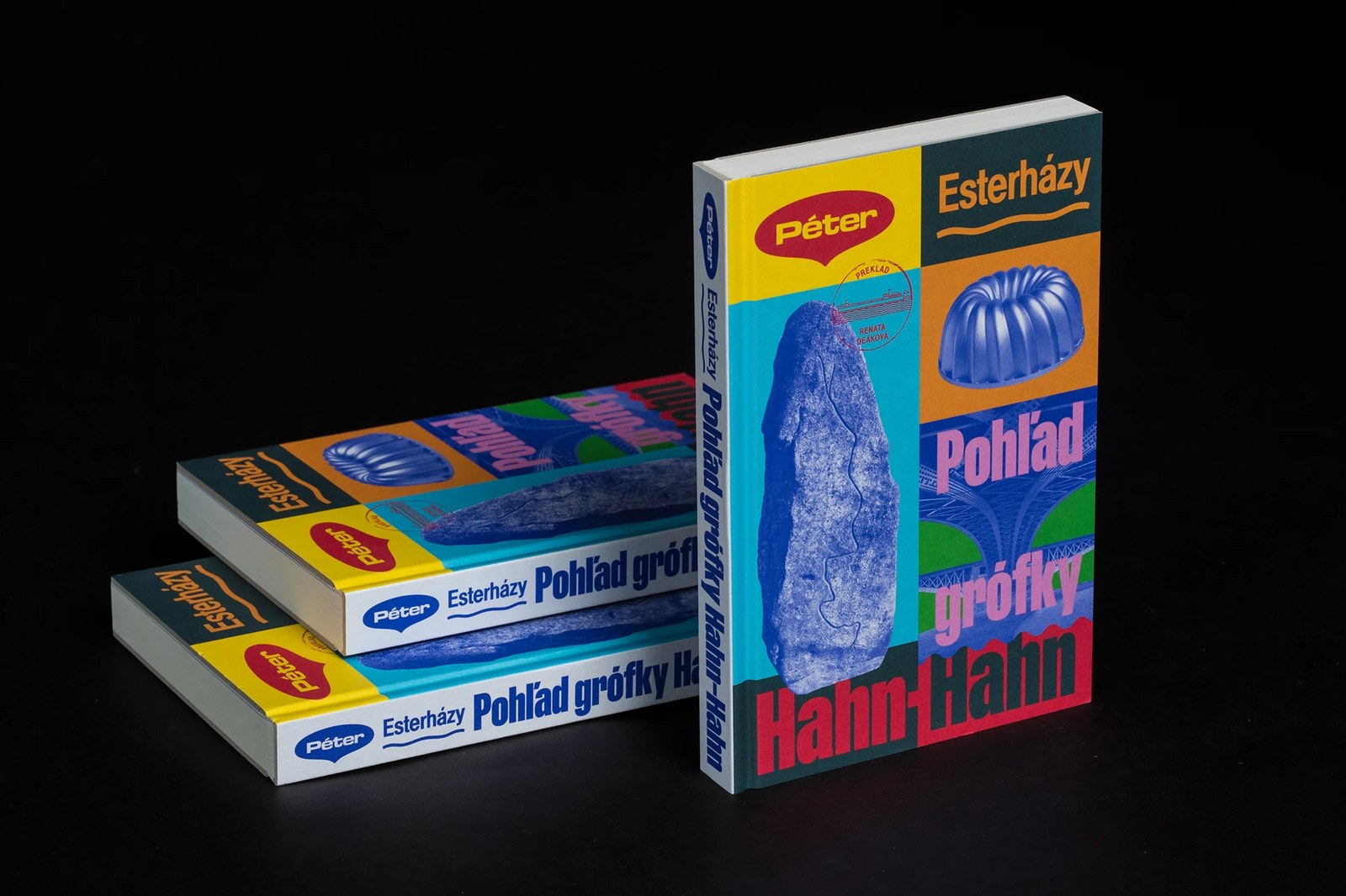Stacked and standing books showcasing the pale ice-blue spine typography and Danube stone halftone illustration by Matúš Hnát