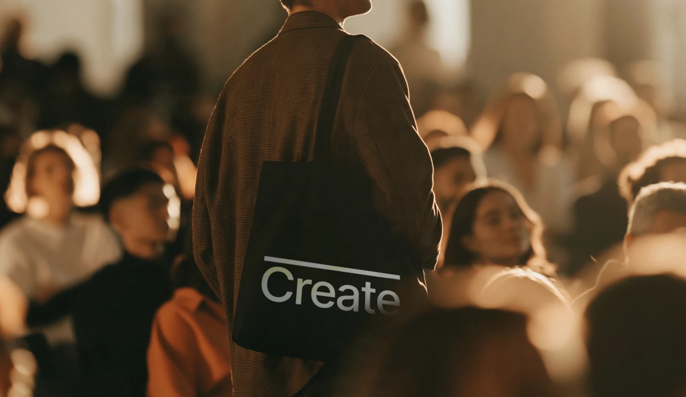Black canvas tote bag printed with the Relentlessly overline bar and 'Create' typography
