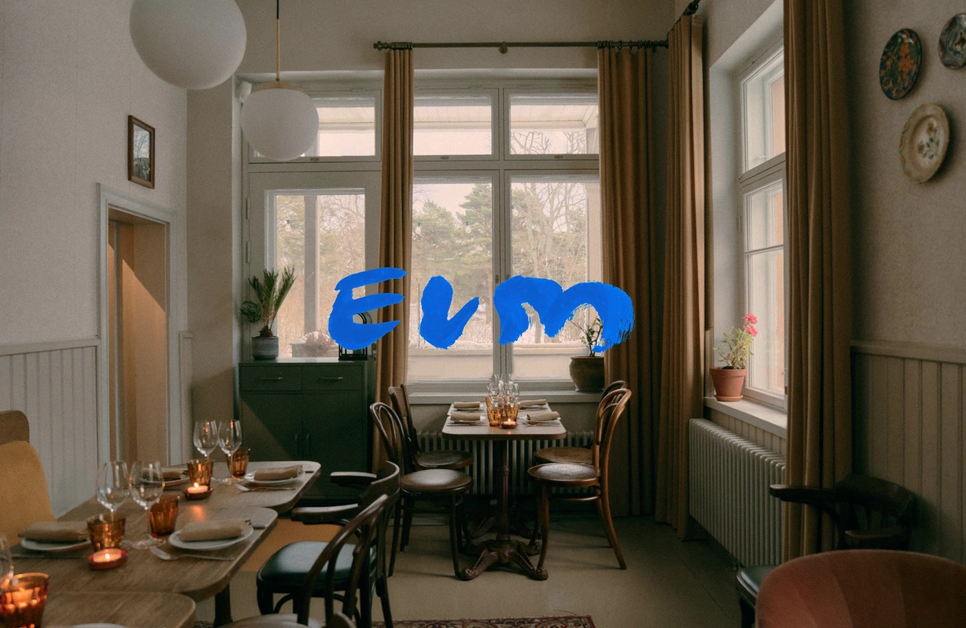 Restaurant Elm dining room window with bright ultramarine blue painted brushstroke logo