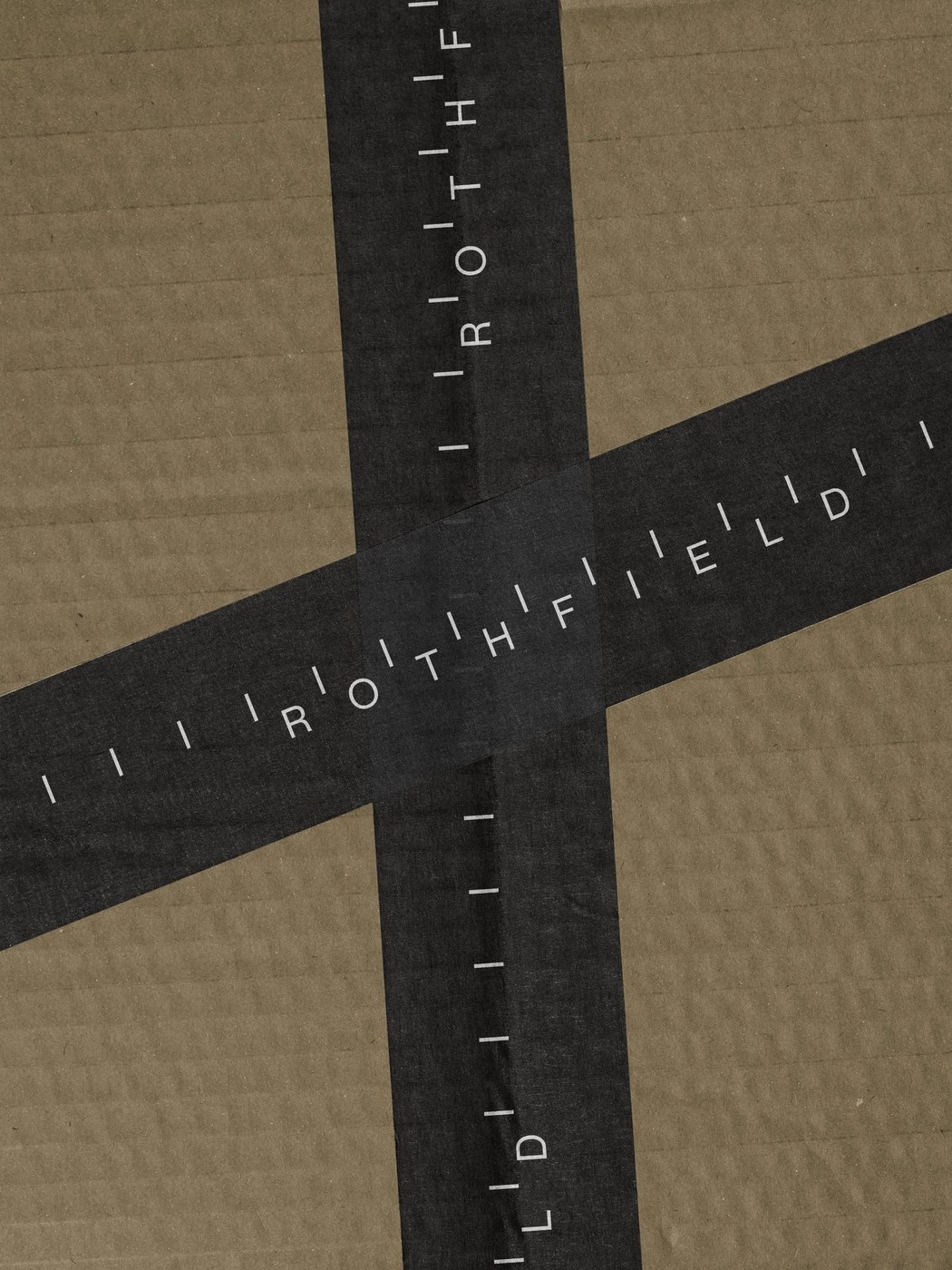 Black printed packaging tape with Rothfield calibration wordmark applied across corrugated kraft cardboard