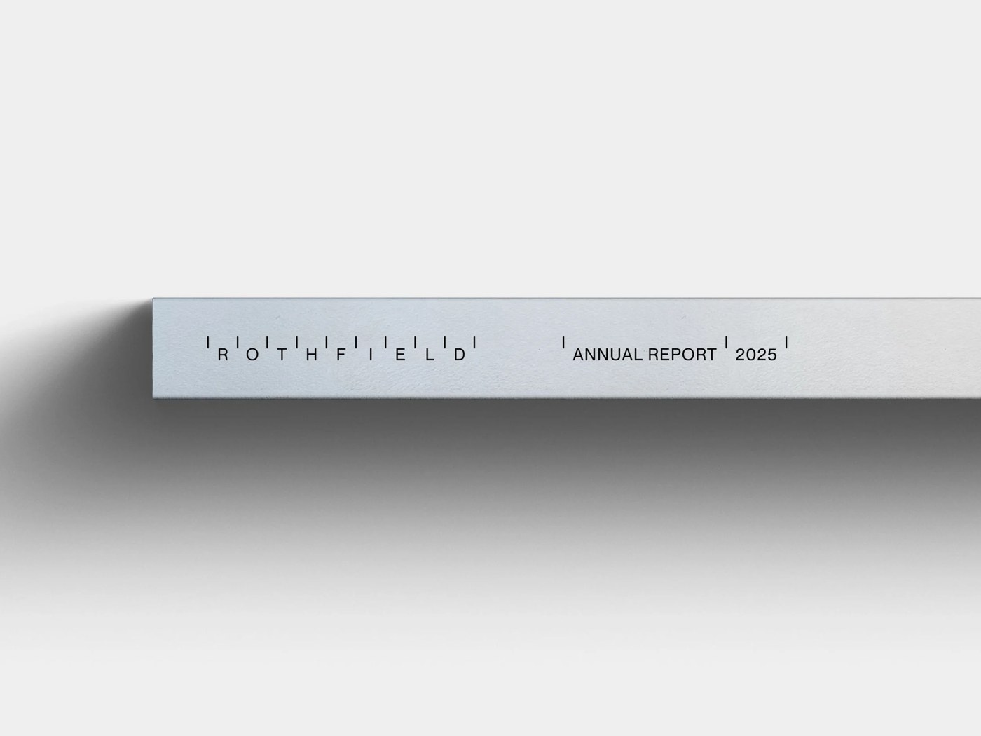 Hardcover spine detail of the Rothfield Annual Report 2025 printed on textured white stock