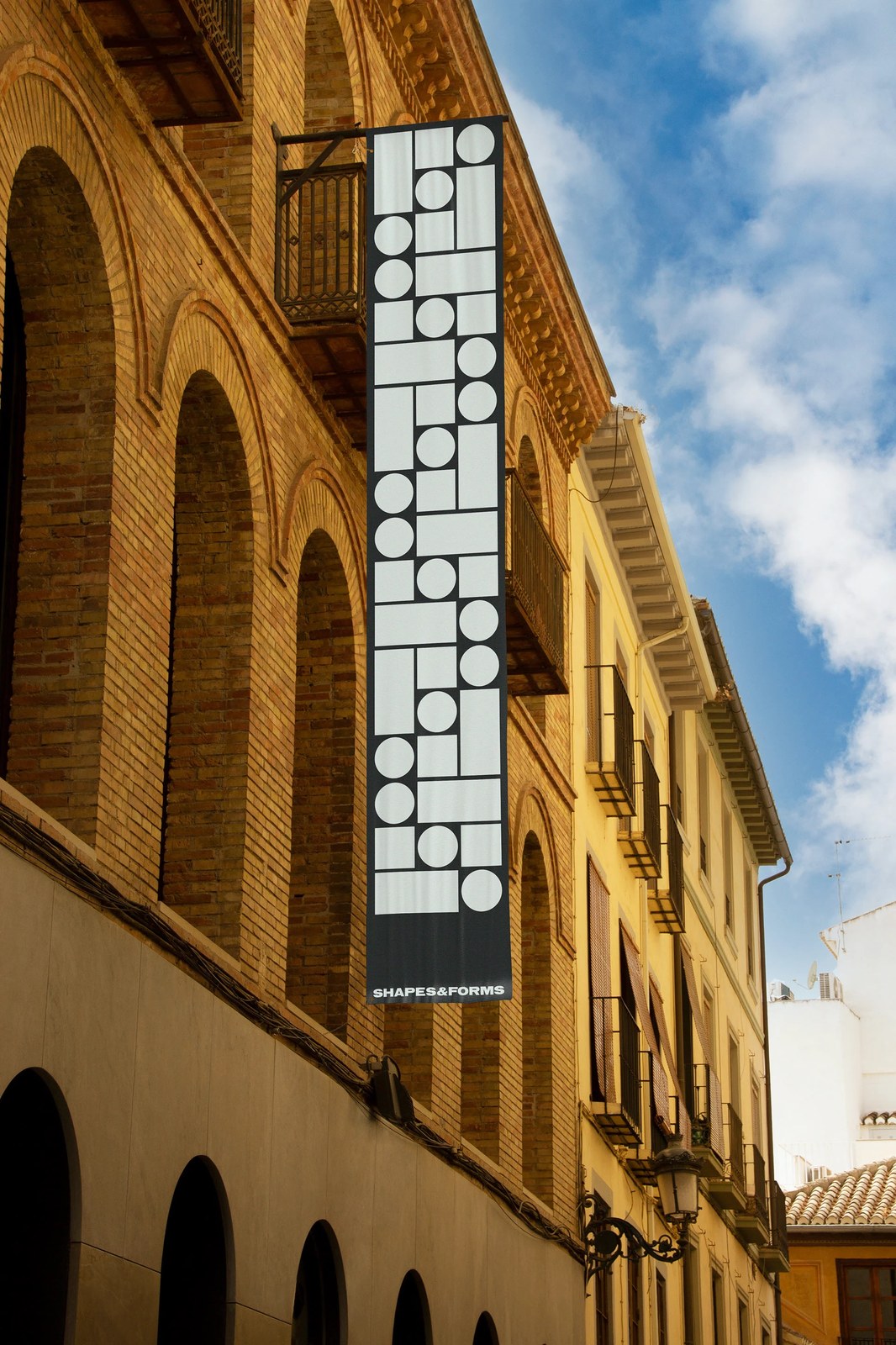 Shapes & Forms vertical black facade banner repeating modular circles and rectangles