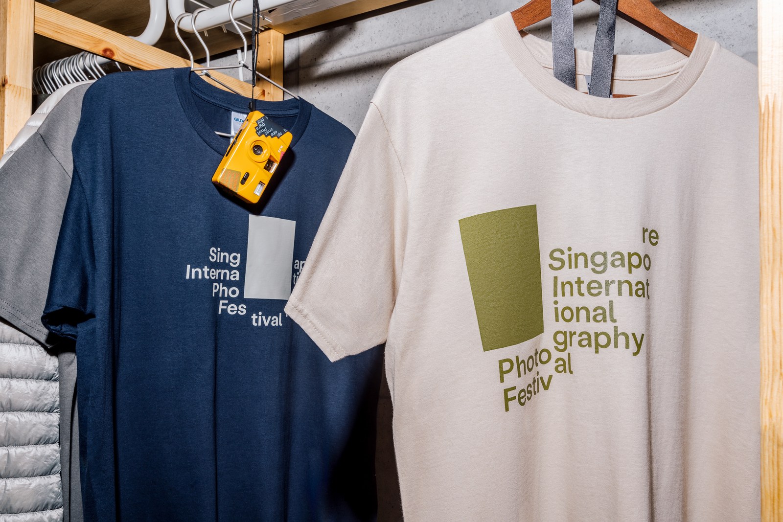 Navy blue and natural ecru cotton SIPF festival t-shirts screenprinted with modular shutter wordmark configurations