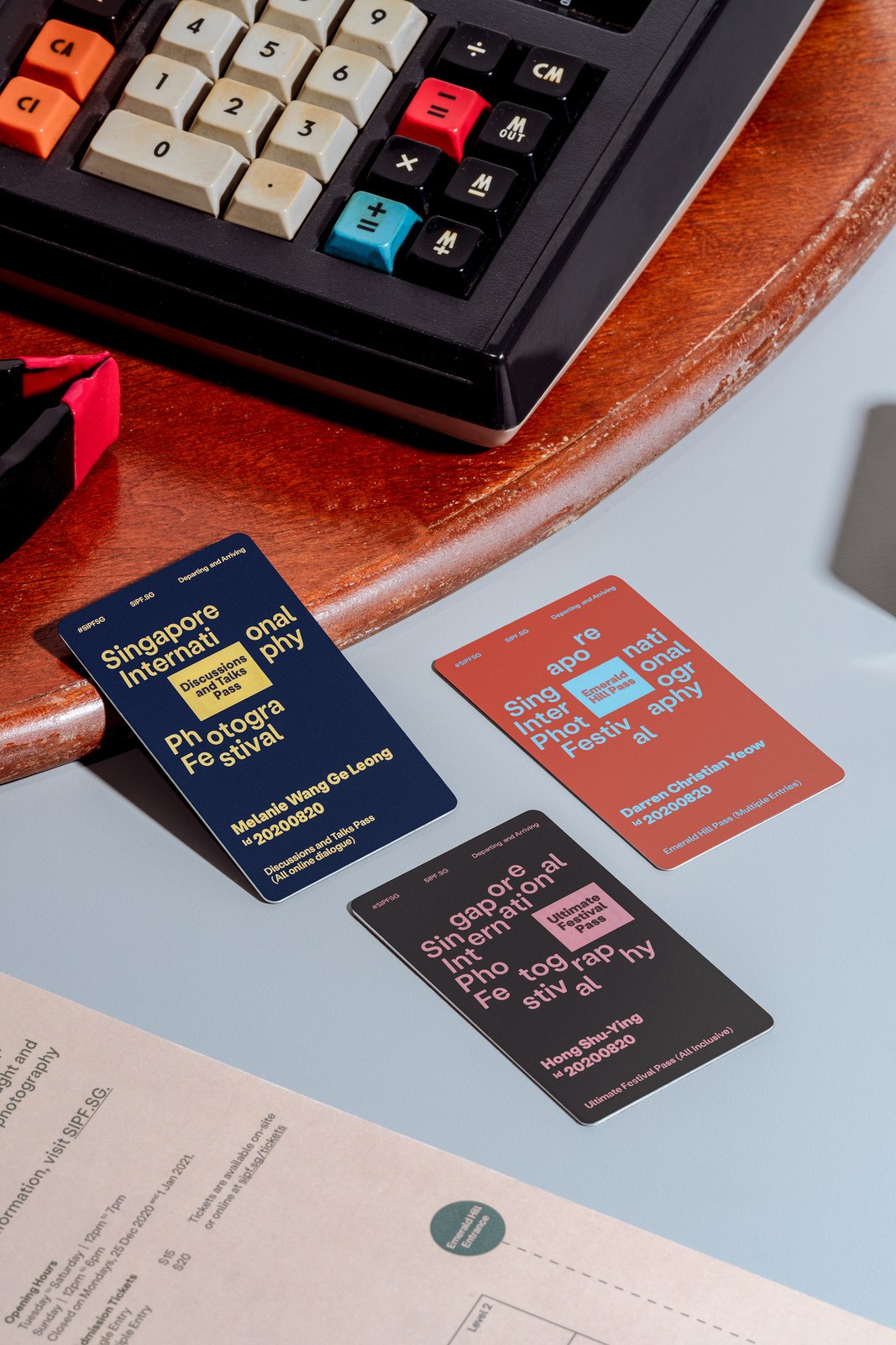 Navy, terracotta, and charcoal SIPF festival access passes with shutter-split typography by Foreign Policy Design