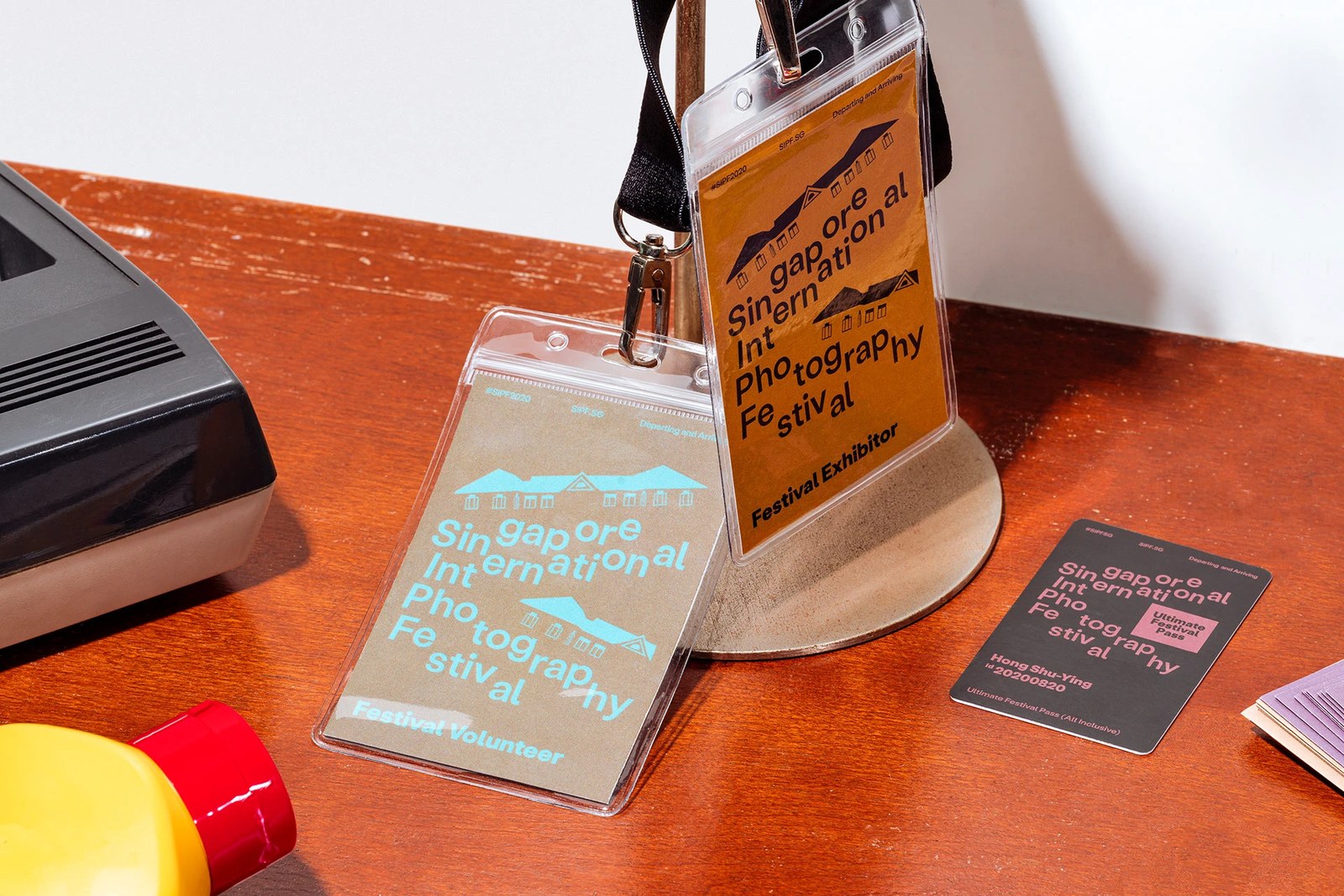 Festival Volunteer and Festival Exhibitor lanyard badges with architectural roofline illustrations for SIPF