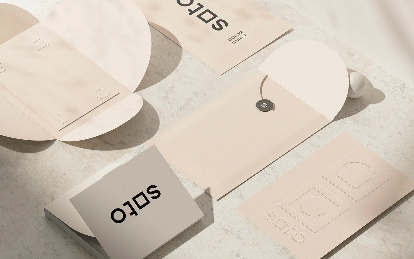 Soto branding color chart envelopes and stationery in blush and sand tones with embossed logo on broadsheet
