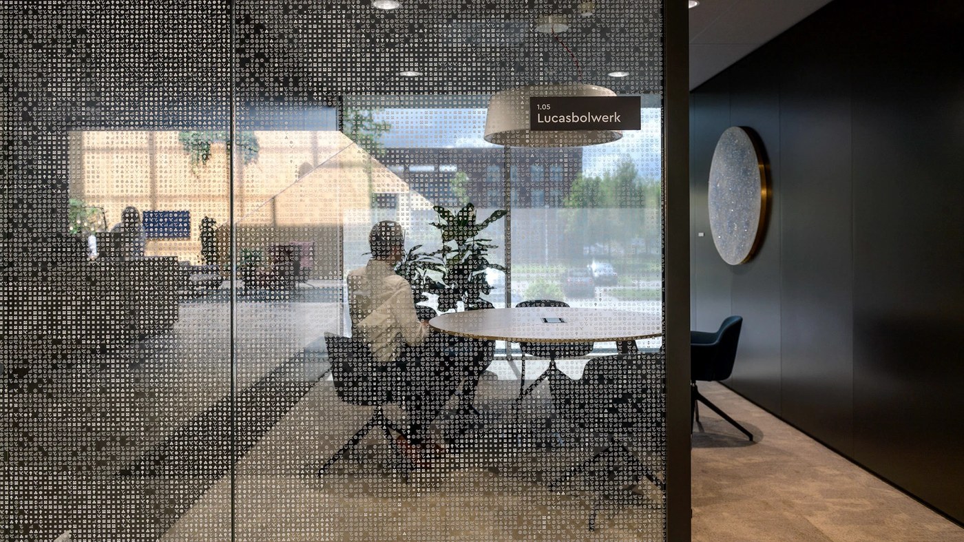 Meeting room glass partition covered in micro data pictograms for spatial design