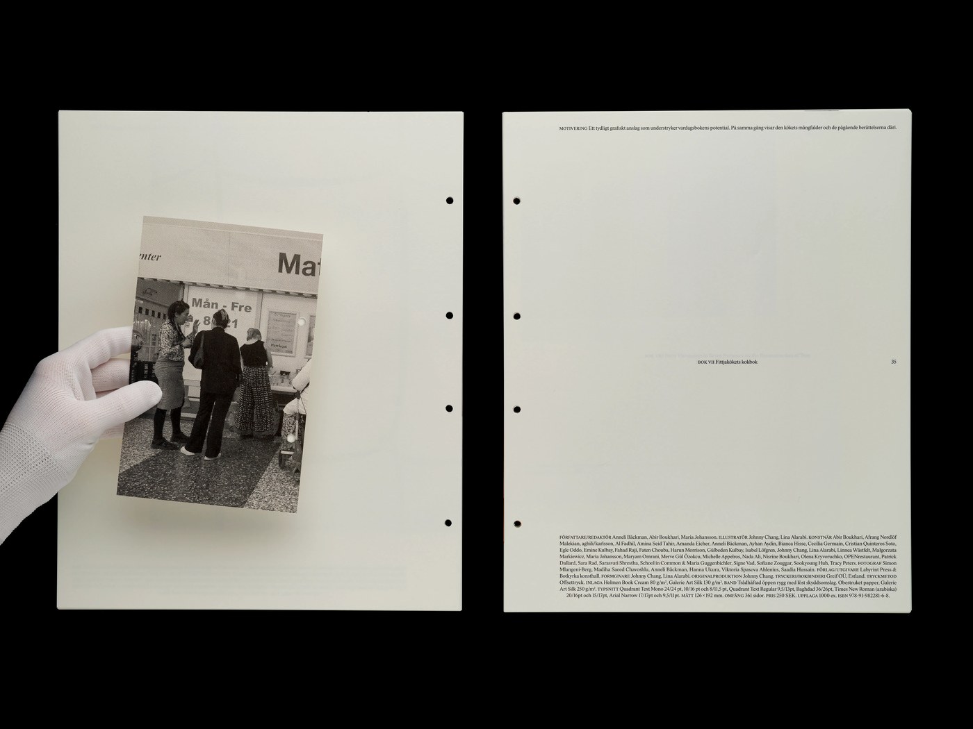 Gloved archival hand holding an untrimmed book fragment within the Svensk Bokkonst editorial design catalogue