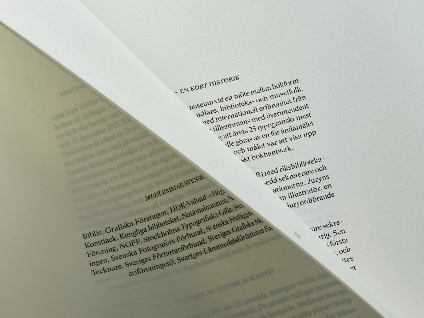 Macro detail of uncoated paper grain and historical typography in Svensk Bokkonst editorial design catalogue