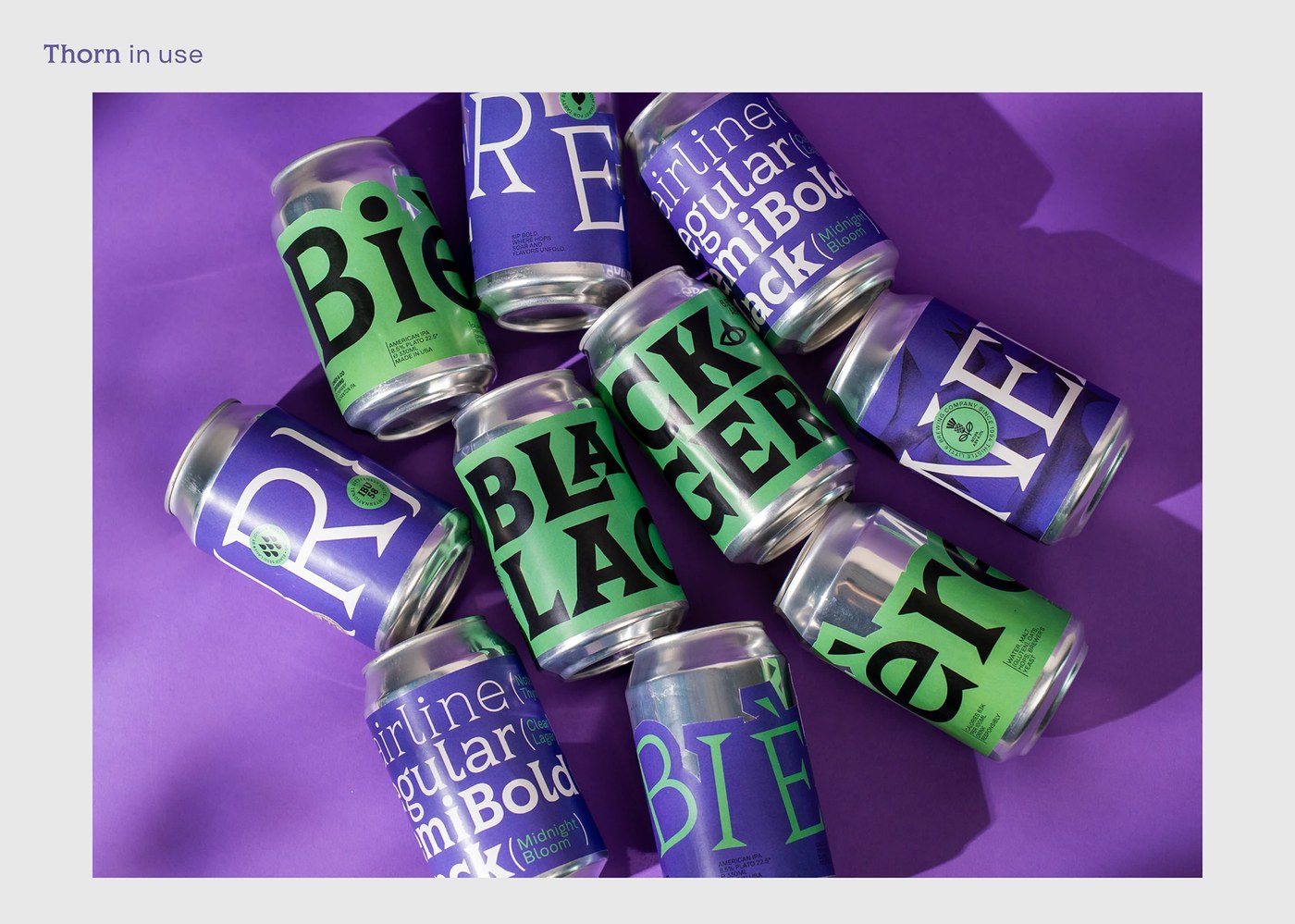 Aluminum beverage cans with Thorn Serif typography labels for black lager by Type Forward